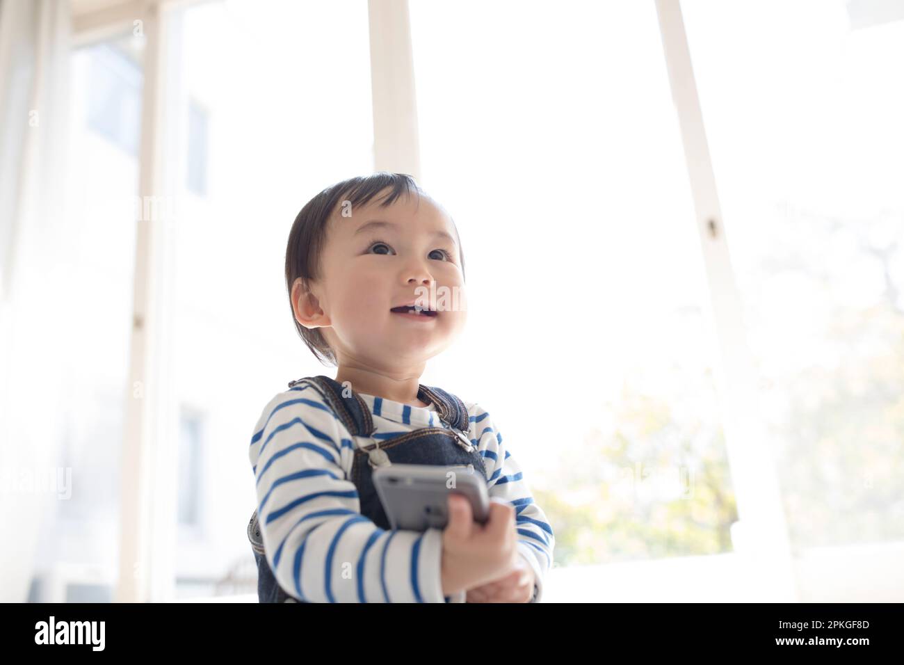 Baby, das mit ihrem Handy rumspielt Stockfoto