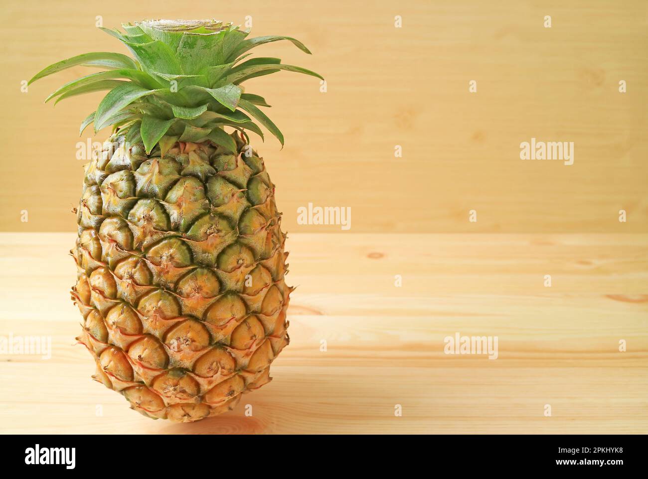 Frische, reife Ananas, isoliert auf Holzhintergrund Stockfoto