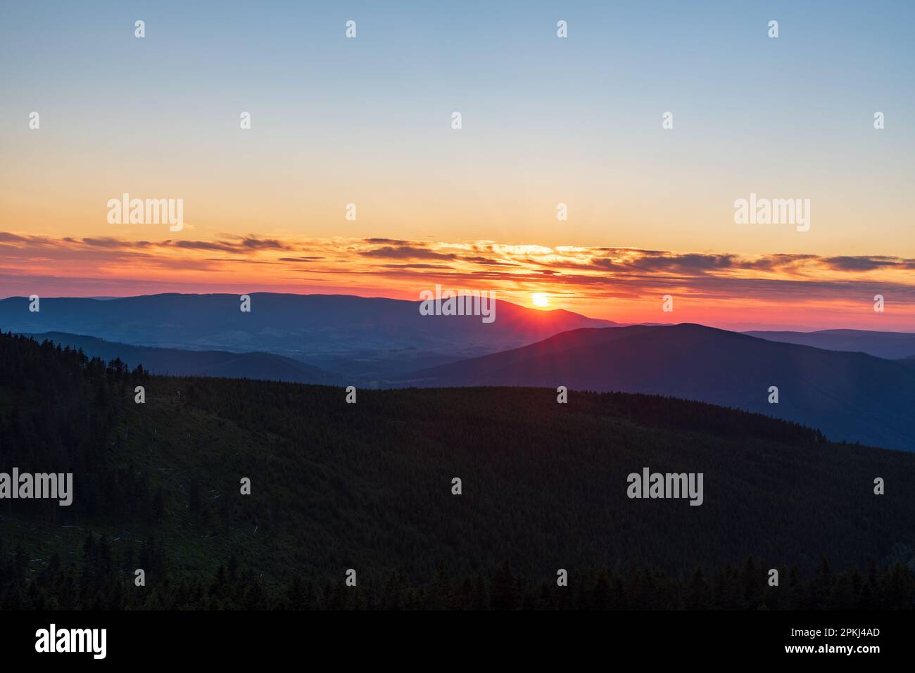 Sonnenuntergang mit Hügeln und farbenfrohem Himmel mit wenigen Wolken vom Dlouhe Strane Hill in den Jeseniky Bergen in der tschechischen republik Stockfoto