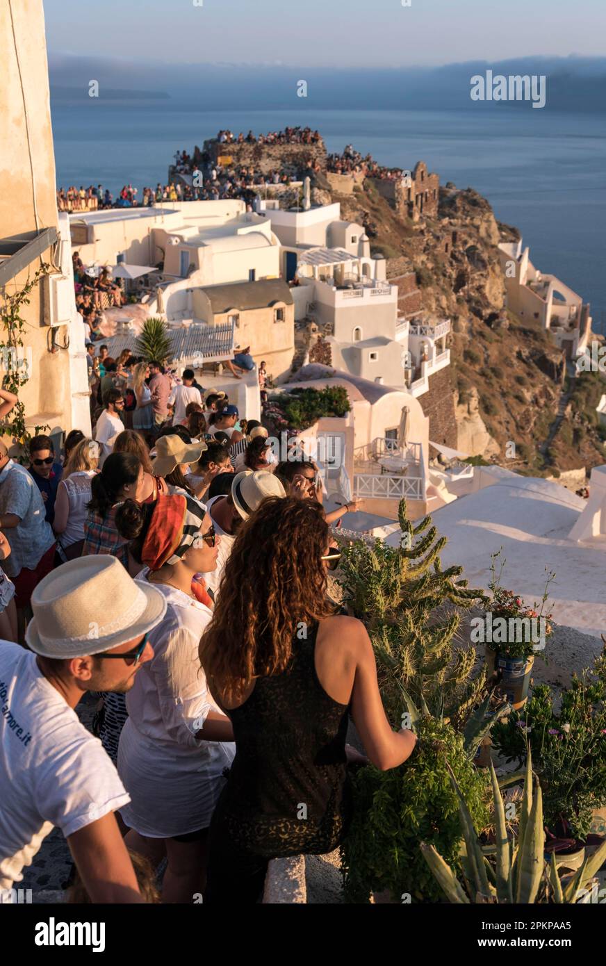 Touristen beobachten den Sonnenuntergang von der Kasteli (Burg) von Agios Nikolaos, Oia, Santorin, Griechenland, Europa Stockfoto