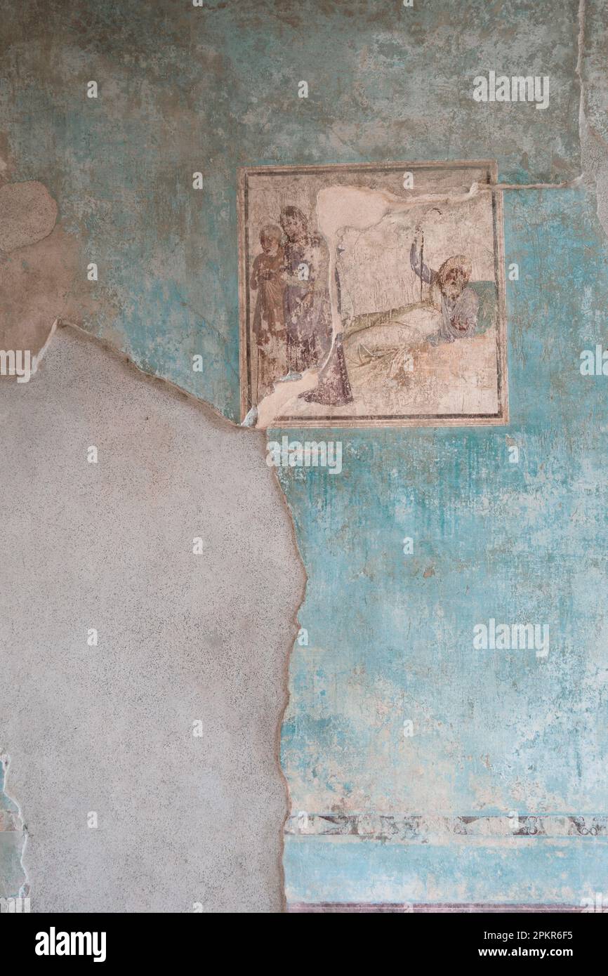 Mit beschädigter Umgebung überlebt ein Fresko in den römischen Ruinen von Pompeji in der Nähe von Neapel und Mt. Vesuv, Italien. Stockfoto