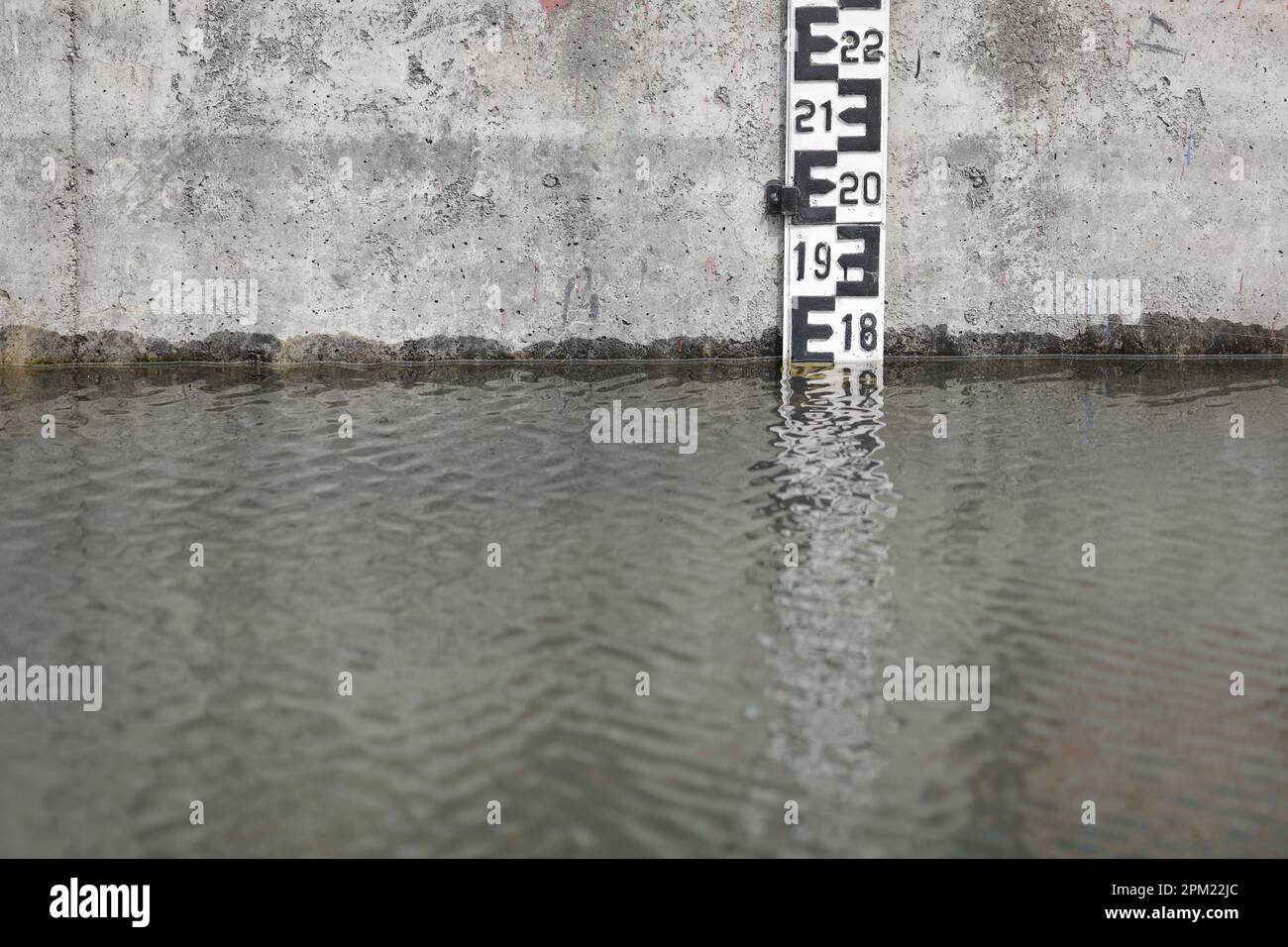 Flusspegelmarkierung in der Nähe einer Schleuse auf einem von Menschenhand geschaffenen Fluss. Stockfoto