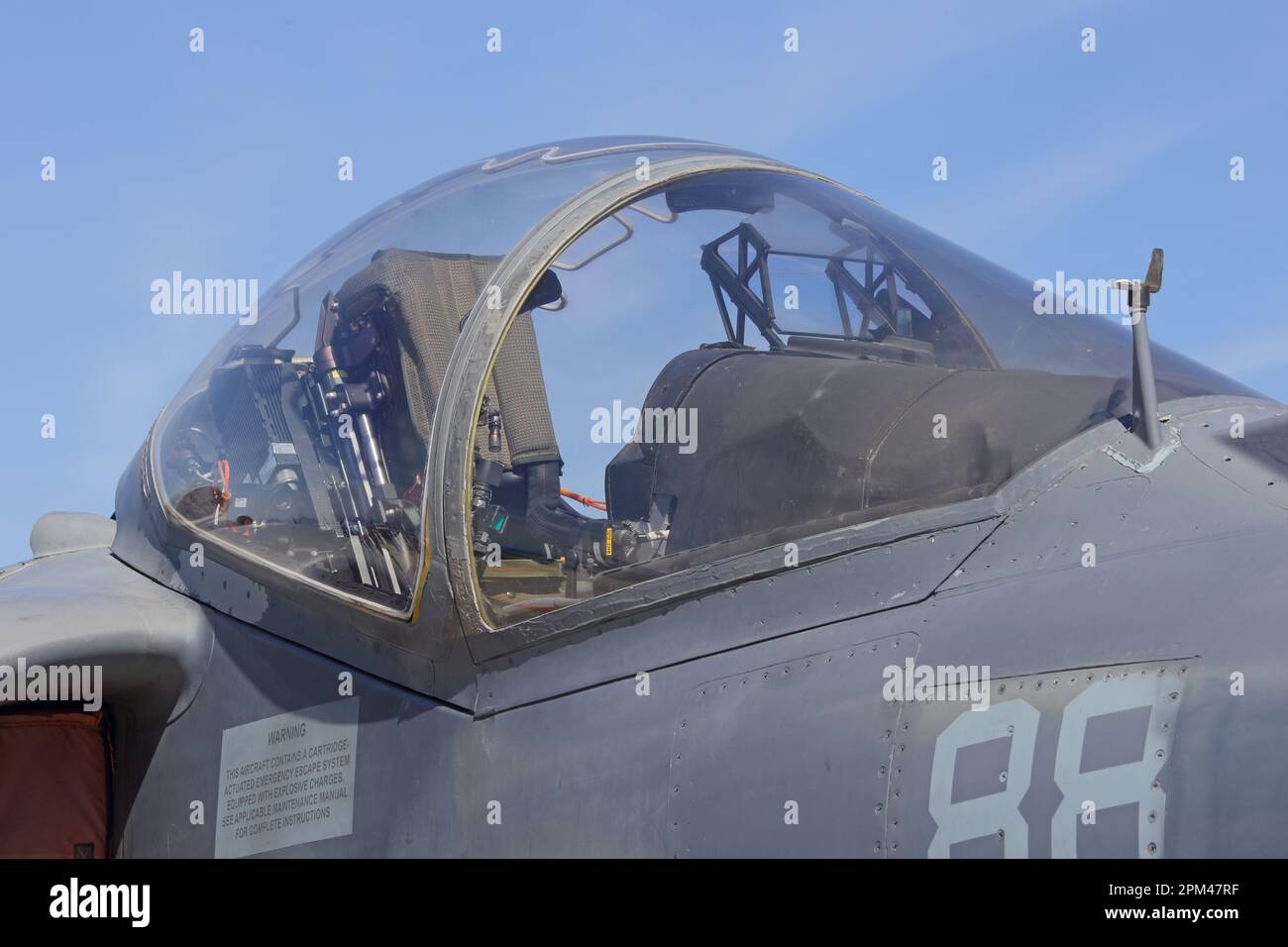 Das Cockpit und das Glasdach eines modernen Kampfjet-Angriffsflugzeugs werden während des Tages aus nächster Nähe gezeigt. Mit blauem Himmel im Hintergrund. Stockfoto