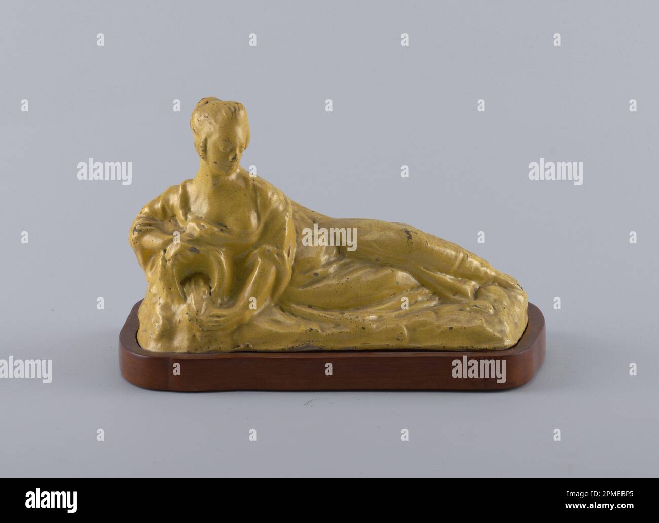 Figur und Sockel; geformtes und glasiertes Steingut, geschnitztes Holz; A) H x B x T: 16,5 x 17,7 x 13,1 cm (6 1/2 x 6 15/16 x 5 3/16 Zoll) b) H x B x T: 2,4 x 29,9 x 14,8 cm (15/16 x 11 3/4 x 5 13/16 Zoll) Stockfoto