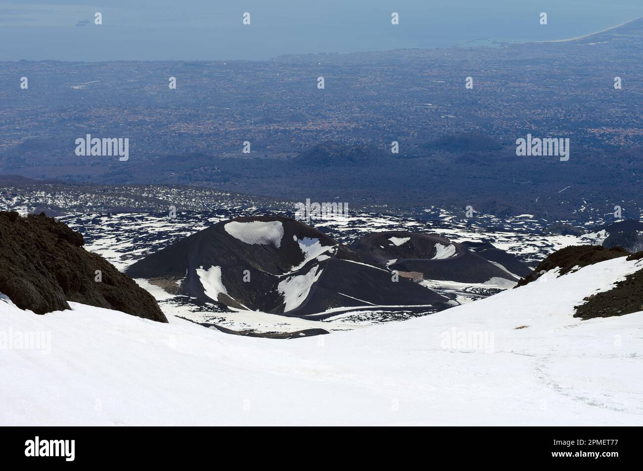 Sizilianische Landschaft mit Vulkankratern aus dem Winter-Ätna-Nationalpark und der Ostküste von Catania, Italien Stockfoto