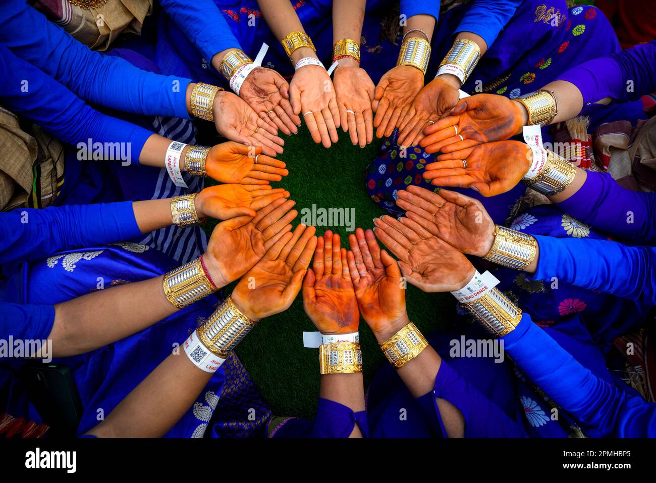 Assamese dancers in traditional attire prepare to perform as they