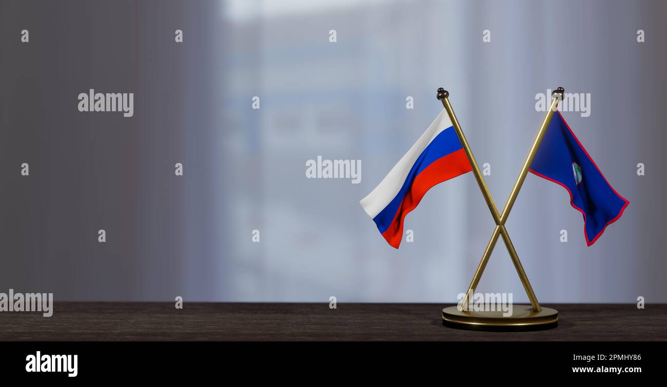 Russland und Guam-Flaggen auf dem Tisch. Verhandlungen zwischen Guam und Russland. Auf wenig unscharfem Hintergrund. 3D Arbeit und 3D Bild Stockfoto