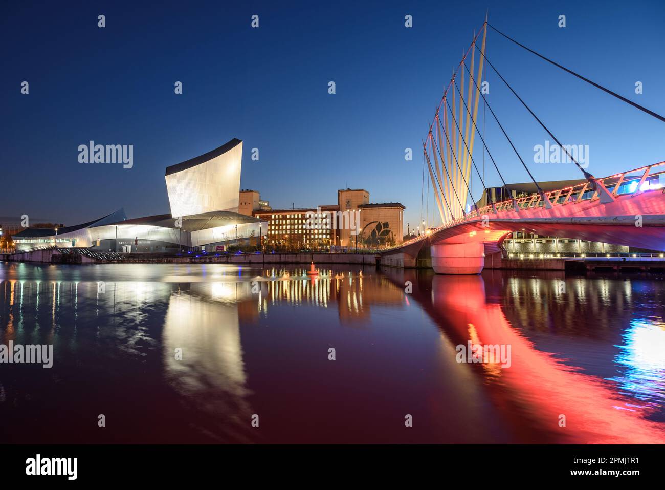 Reflexion des Wahrzeichens des Salfords Quay, Imperial war Museum at Night, Manchester UK Stockfoto