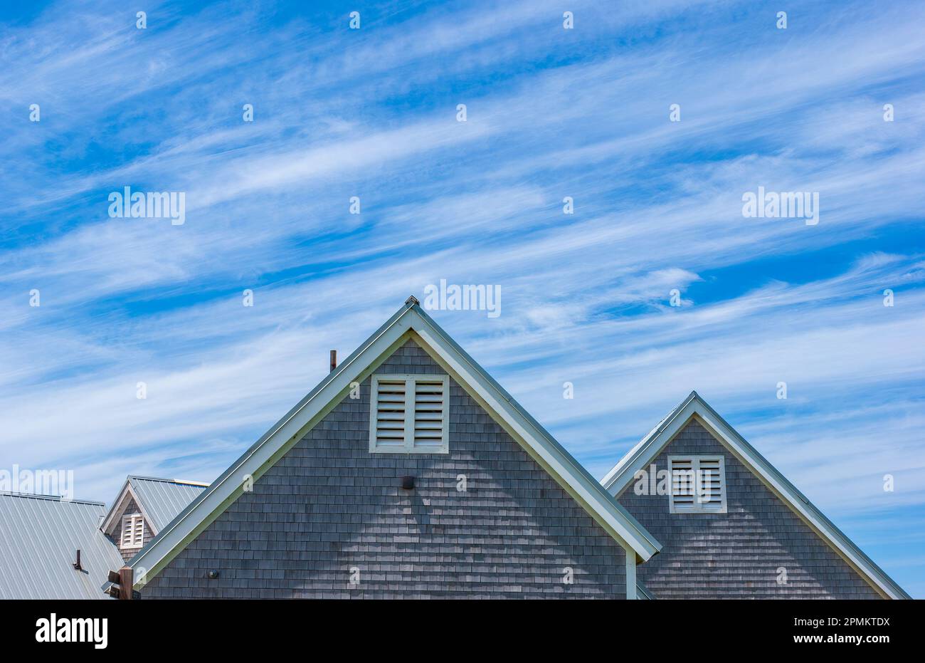 Cavendish Beach. Gebäudegebäude mit Holzschindelgleis. Dächer mit weißer Giebelfaszie vor blauem Himmel und Cirrus-Wolken. PEI-Nationalpark Stockfoto
