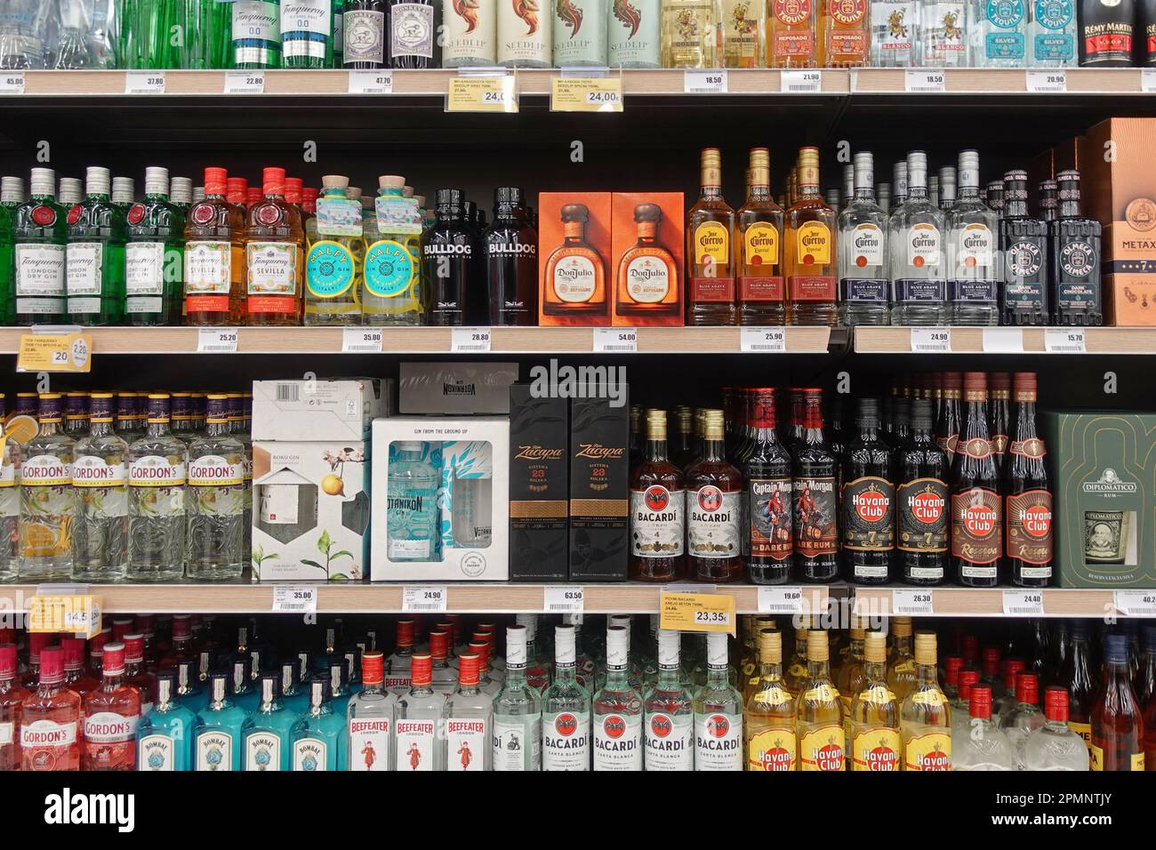 Athen, Griechenland - 6. März 2023: Tequila Gin und Rum Alkohol Getränkeflaschen verschiedene Etiketten zum Verkauf im Spirituosengeschäft. Stockfoto