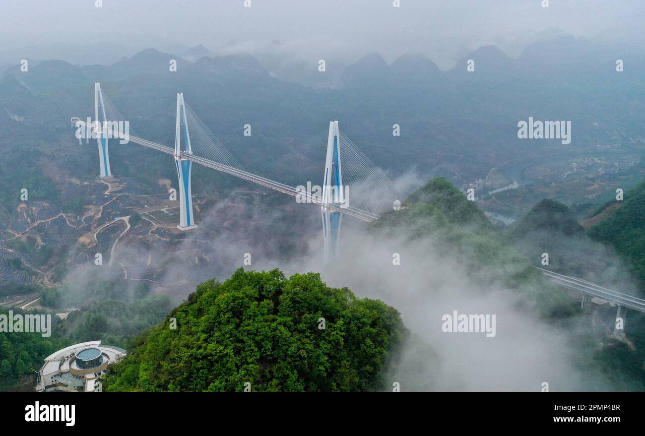 (230414) -- GUIYANG, 14. April 2023 (Xinhua) -- Dieses Luftfoto wurde am 14. April 2023 aufgenommen und zeigt die Pingtang Grand Bridge auf der Schnellstraße zwischen Pingtang und Luodian in der Provinz Guizhou im Südwesten Chinas. Brücken sind ein unverkennbares Merkmal der Verkehrsinfrastruktur in Guizhou. Die Provinz ist zu 92,5 Prozent von Bergen und Hügeln bedeckt und hat seit den späten 1970er Jahren fast 30.000 Brücken gebaut. Heute beherbergt sie fast die Hälfte der 100 höchsten Brücken der Welt. Dank des Baus von Brücken wird die bergige Provinz tiefgreifend in die na integriert Stockfoto