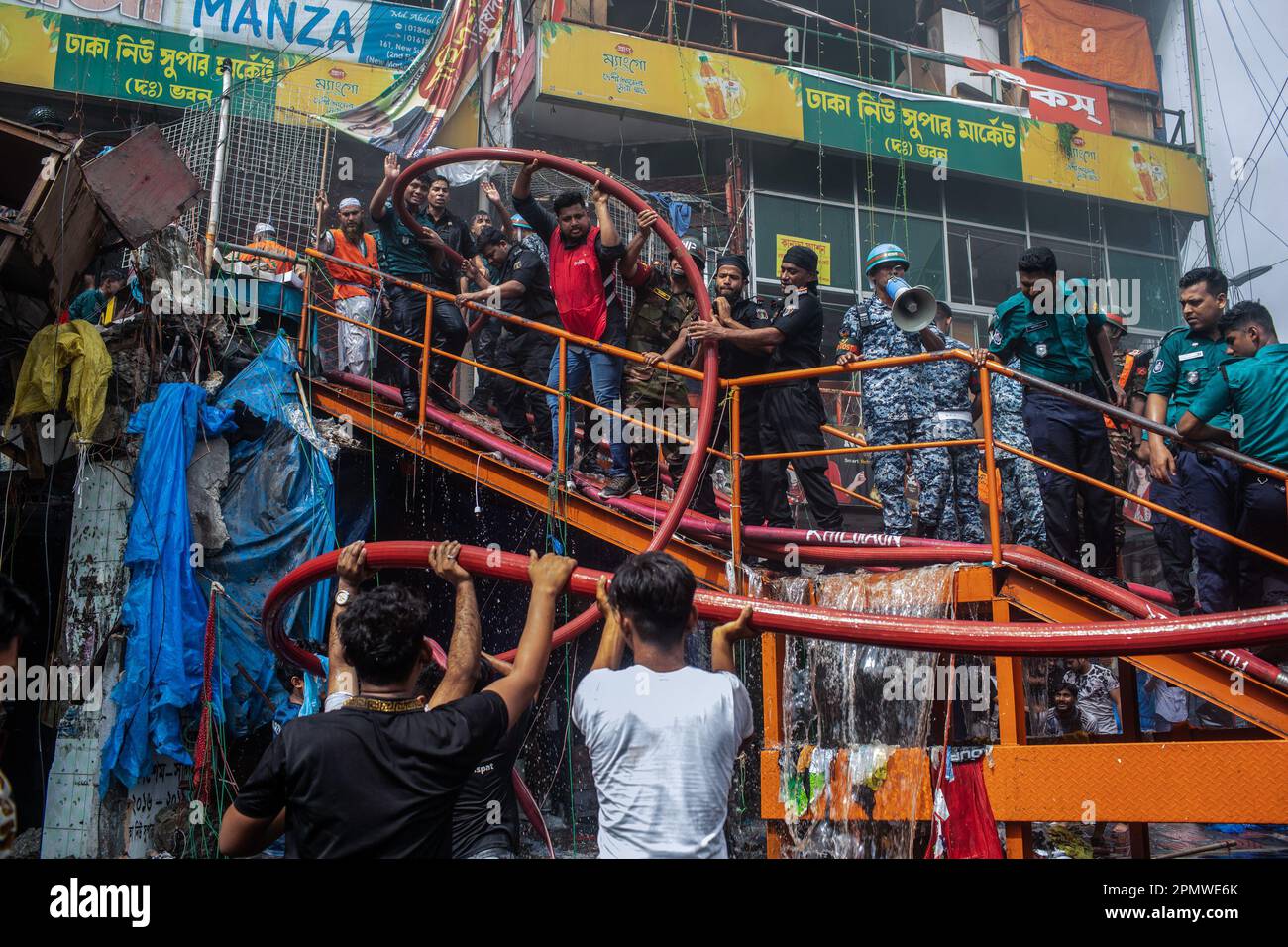 Dhaka, Bangladesch. 15. April 2023. Die drei uniformierten Militärdienste des Landes, Armee, Marine, Luftwaffe und das Schnelleinsatzbataillon helfen, ein Feuer im New Supermarket in Dhaka zu löschen. In Dhakas neuem Supermarkt, einem der größten Bekleidungsmärkte des Landes, vor Eid-ul-Fitr, hat ein massives Feuer die Geschäfte ausgelöscht. Einsatzkräfte der Armee, der Luftwaffe, des Schnelleinsatzbataillons, der Polizei von Bangladesch und des Grenzschutzes Bangladesch haben sich mit 28 Feuerwehr- und Zivilschutzeinheiten zusammengetan, um am Samstag die Flammen zu zähmen. Kredit: SOPA Images Limited/Alamy Live News Stockfoto
