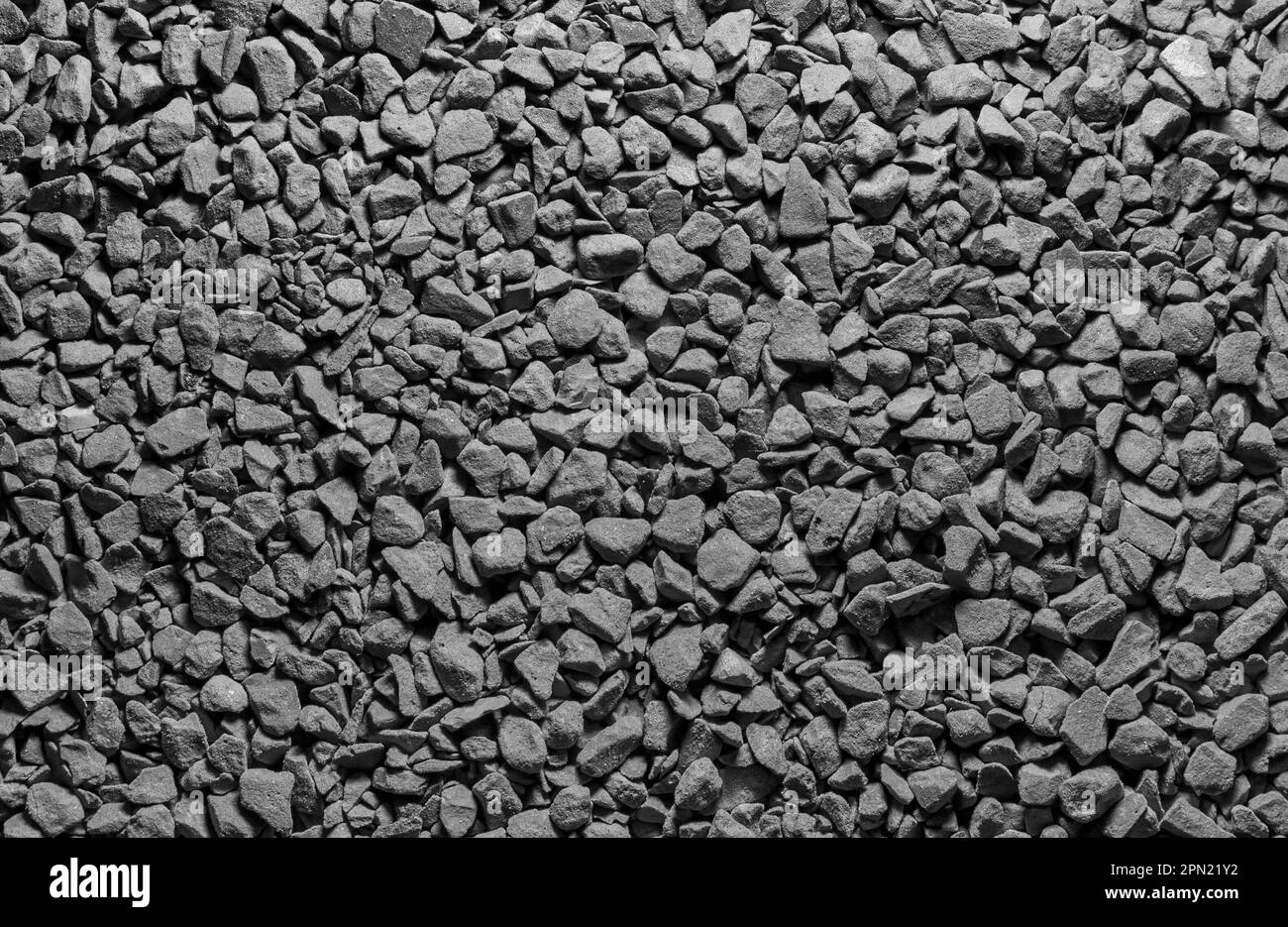 Kieselsteine schleifen schwarze und weiße Kaffeetexturen in Makro Stockfoto