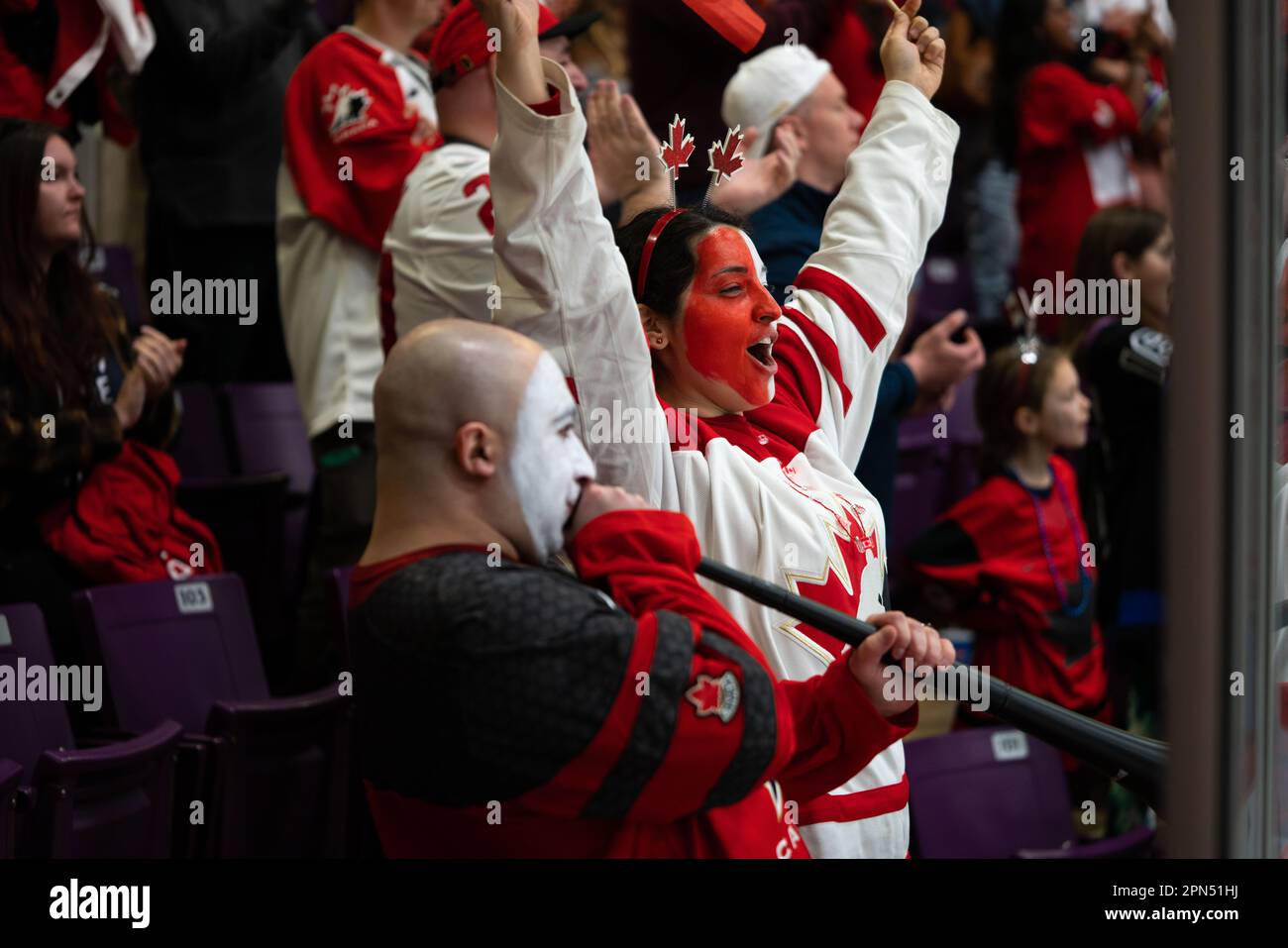 Kanadische Fans feiern den Sieg beim Women's World Hockey Championship Game in Brampton, Ontario, Kanada. Glückliche Frau, die auf der Tribüne jubelt. Stockfoto