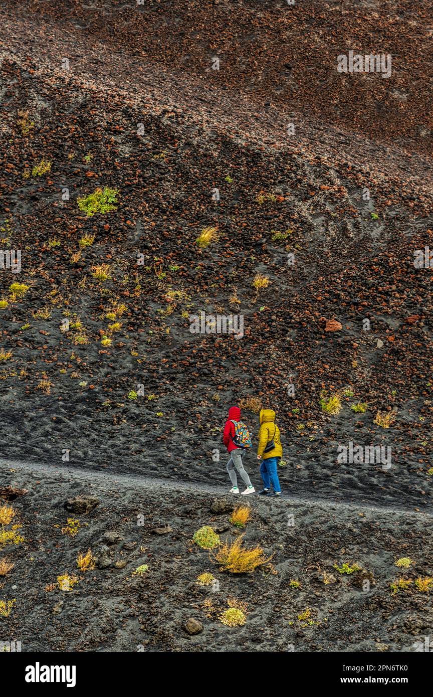 Touristen entlang des Pfads, der zum oberen Krater der Silvestri-Krater führt. Ätna-Nationalpark, Sizilien, Italien, Europa Stockfoto