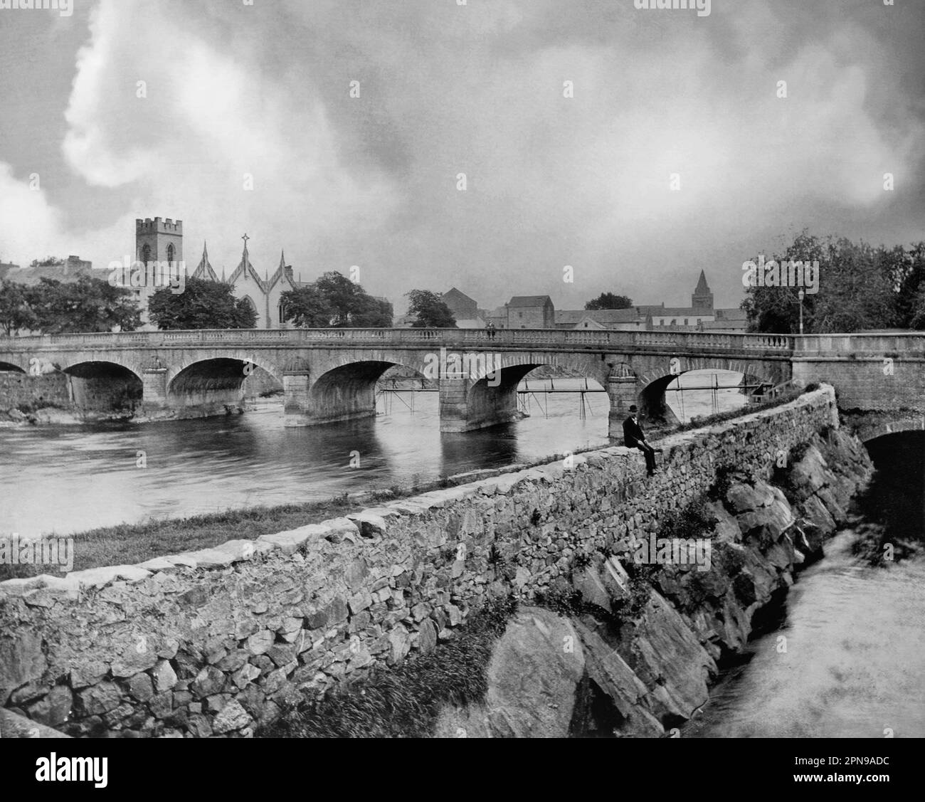 Ein Blick aus dem späten 19. Jahrhundert auf die West Bridge über den Corrib River in Galway City, Irland, mit Pater Dalys Kapelle am Ufer. Pater Daly war ein sehr talentierter Mann und ein fleißiger stadtkommissar, Mitglied der Lough Corrib Navigation Trustees, Kandidat für den Bischof von Galway und Mitglied des Gas Board. Er hat während seines langen Lebens viel Arbeit geleistet und war jahrzehntelang ein führender Bürger der Stadt. Stockfoto Ein Blick aus dem späten 19. Jahrhundert auf die West Bridge über den Corrib River in Galway City, Irland, mit Pater Dalys Kapelle am Ufer. Pater Daly war ein sehr talentierter Mann und ein fleißiger stadtkommissar, Mitglied der Lough Corrib Navigation Trustees, Kandidat für den Bischof von Galway und Mitglied des Gas Board. Er hat während seines langen Lebens viel Arbeit geleistet und war jahrzehntelang ein führender Bürger der Stadt. Stockfoto