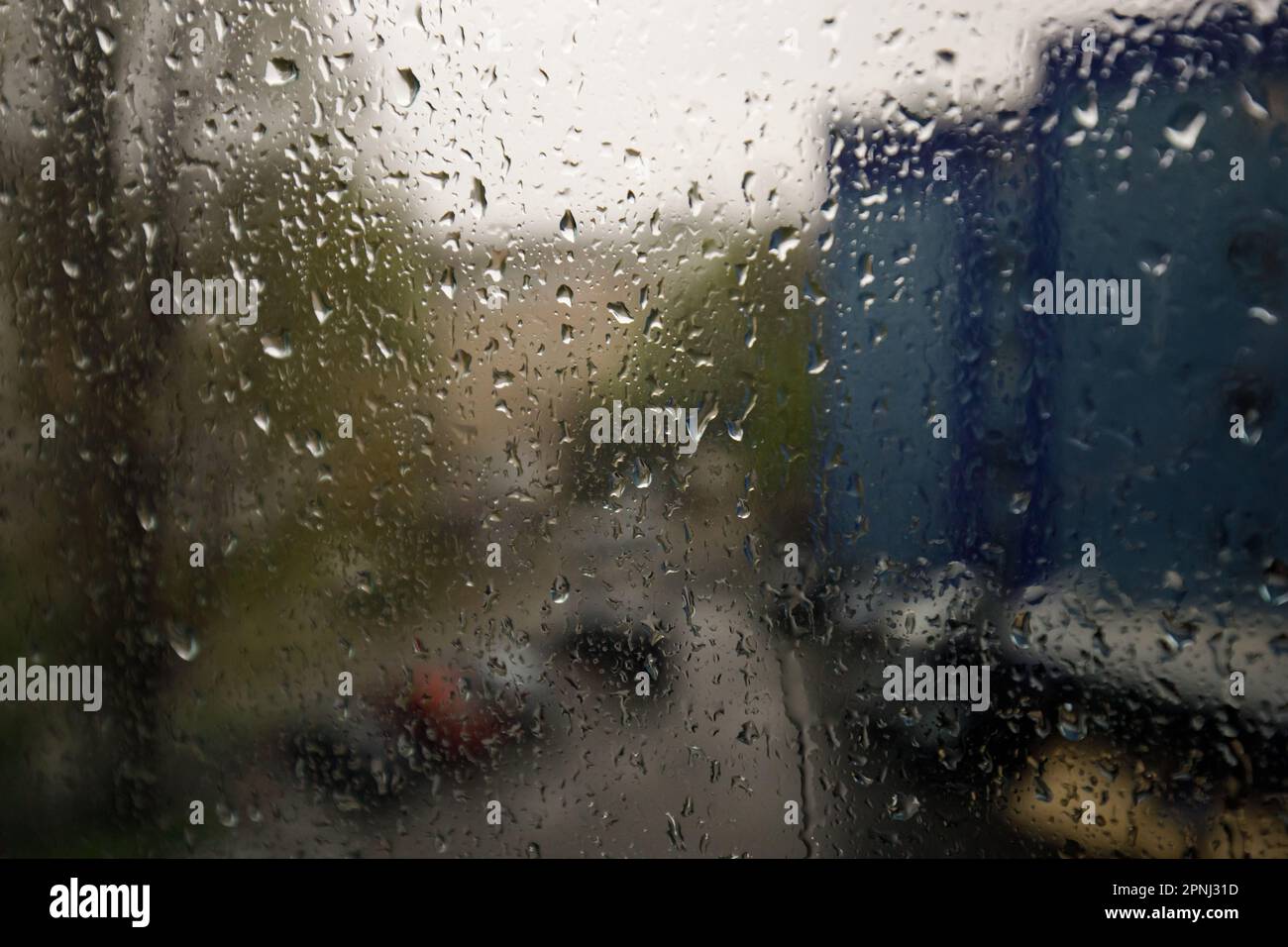 Das Glas eines Fensters mit natürlichen Regentropfen (Wassertropfen) Stockfoto