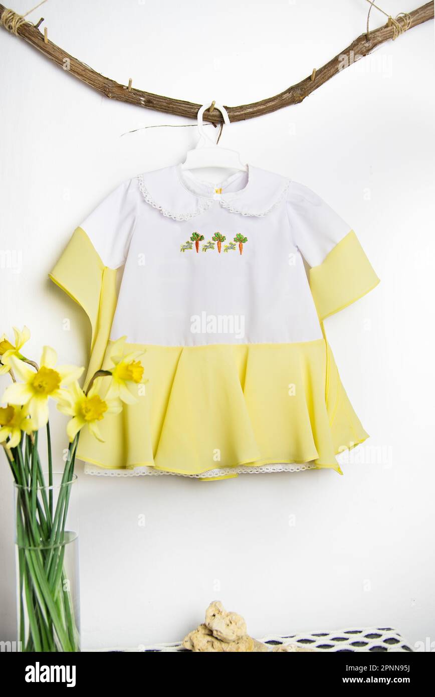 Kinderkleid, Outfit für ein Fotoshooting, süßes Kleid für ein 1-jähriges Mädchen, weiß mit Gelb Stockfoto