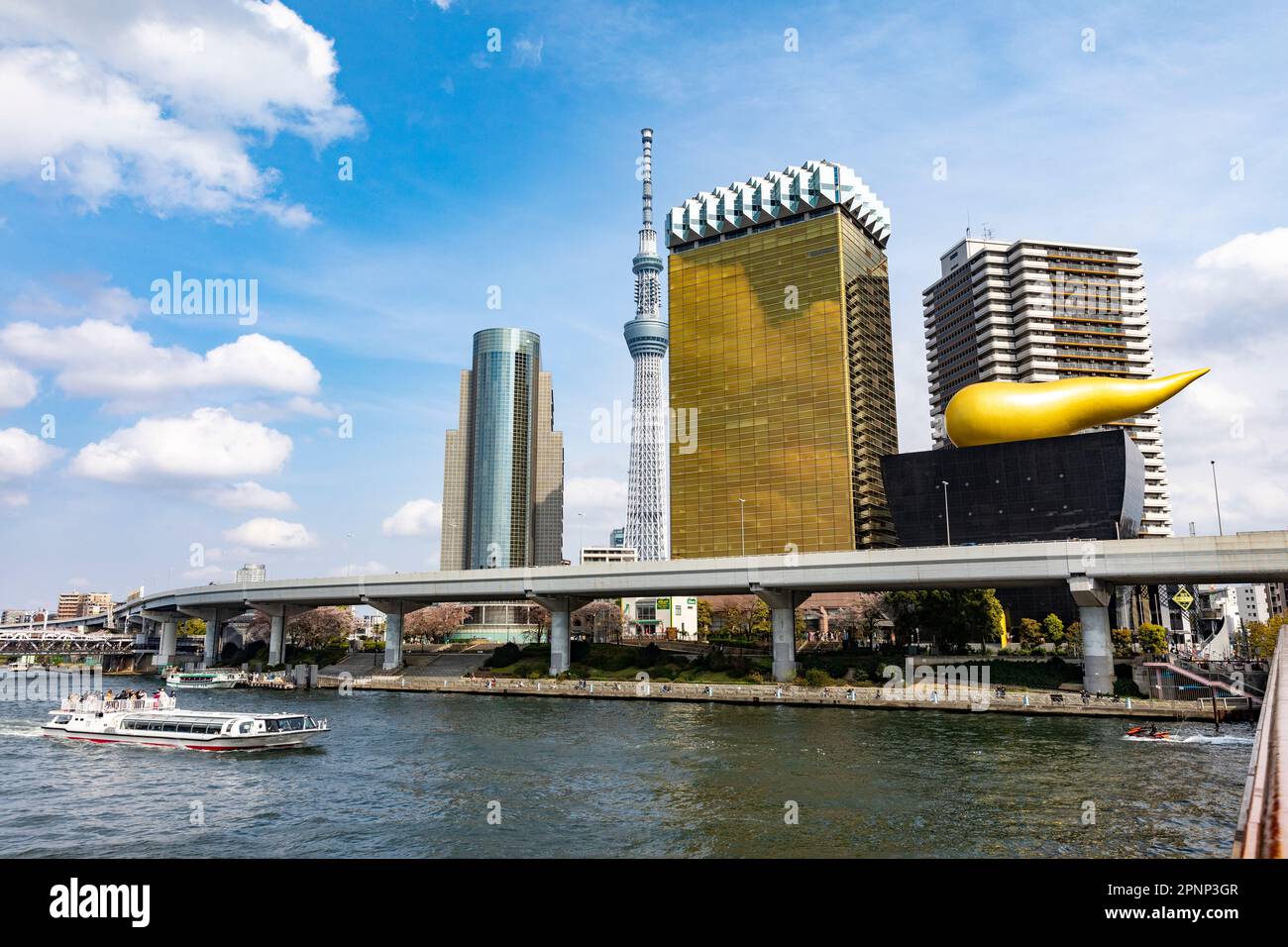 Sumida-Fluss Toky0. Das Flussboot passiert den höchsten Turm des Tokyo Sky Tree und die Asahi-Flamme, Bierhalle und Büros, April 2023, Japan, Asien Stockfoto
