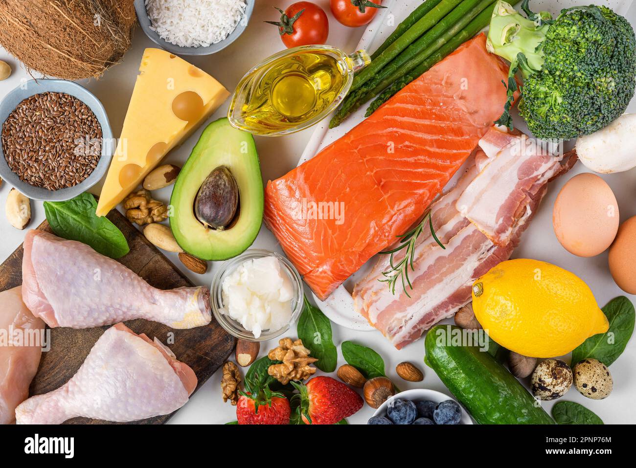 Ausgewogene kohlenhydratarme Keto-Diät. Nahrungsquellen von Protein, gesunde Fette, Kohlenhydrate. Draufsicht. Fisch, Fleisch, Gemüse, Obst, Nüsse, Eier für ketogene Würfel Stockfoto