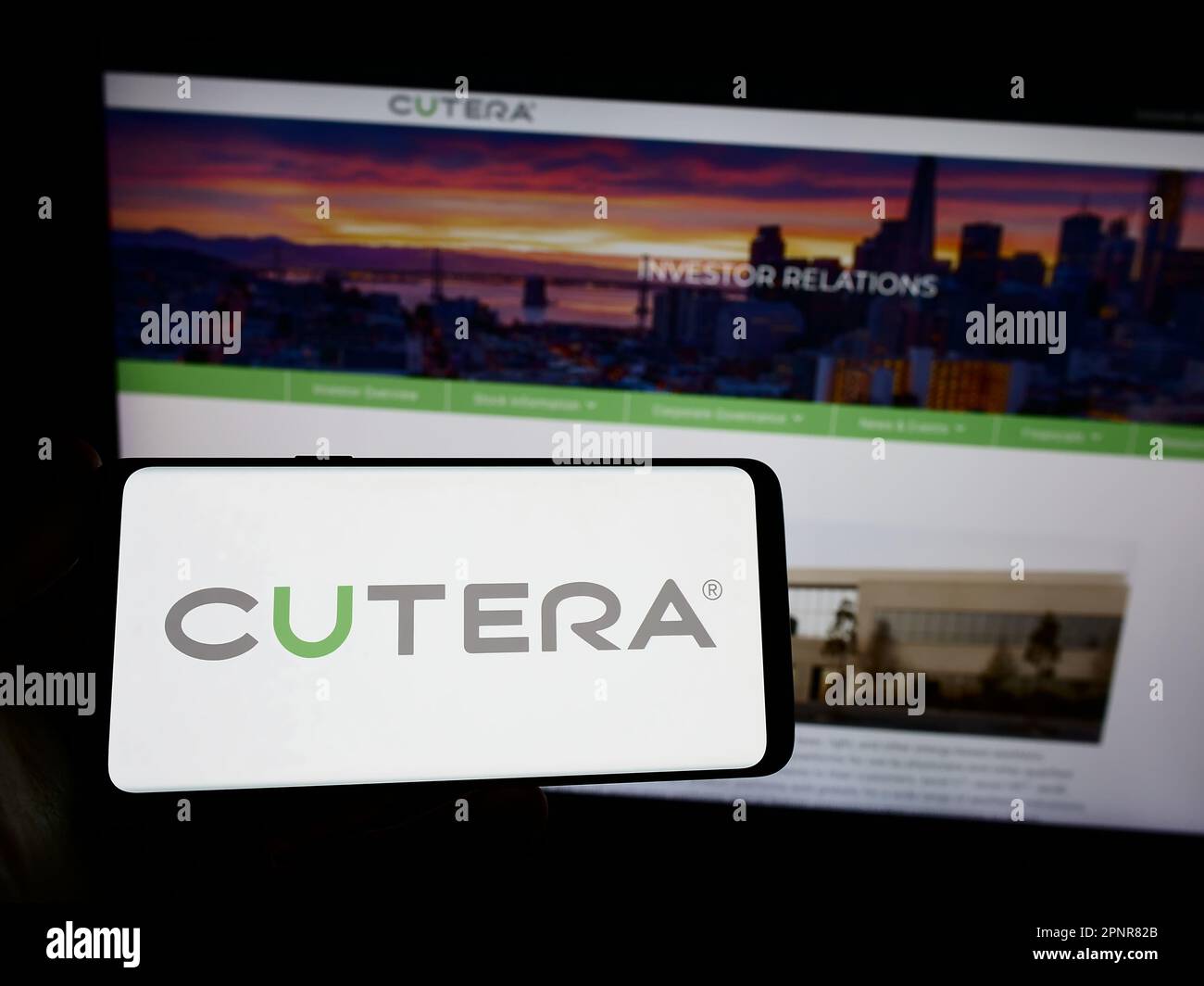 Person, die ein Smartphone mit dem Logo des US-Medizintechnikunternehmens Cutera Inc. Auf dem Bildschirm vor der Website hält. Konzentrieren Sie sich auf das Display des Telefons. Stockfoto