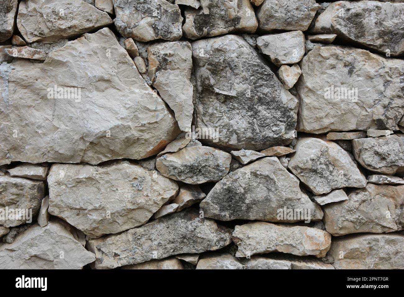 Eine Wand aus Steinen – eine Oberflächenstruktur Stockfoto