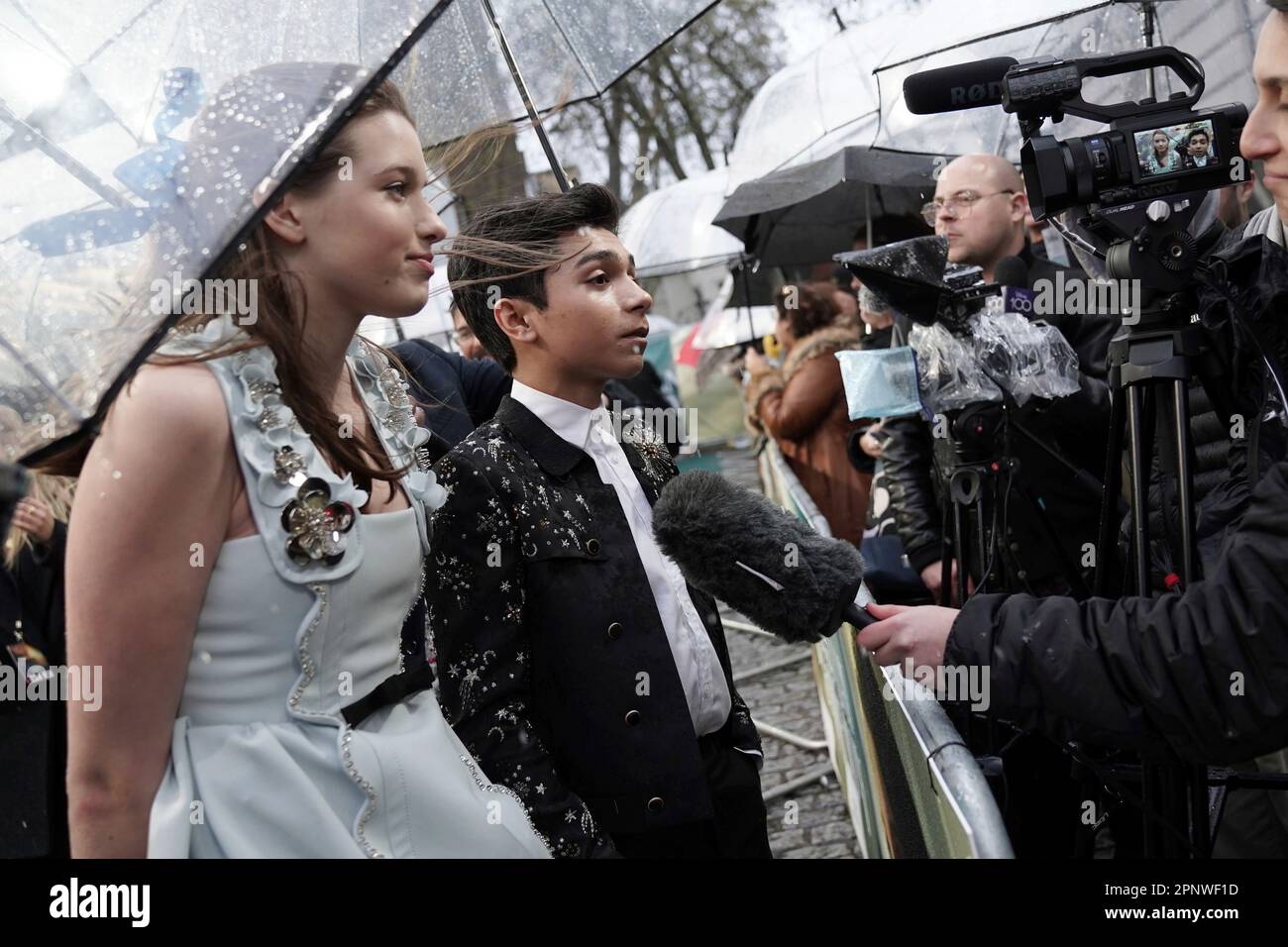 Alexander Molony, left, and Ever Anderson are interviewed upon arrival