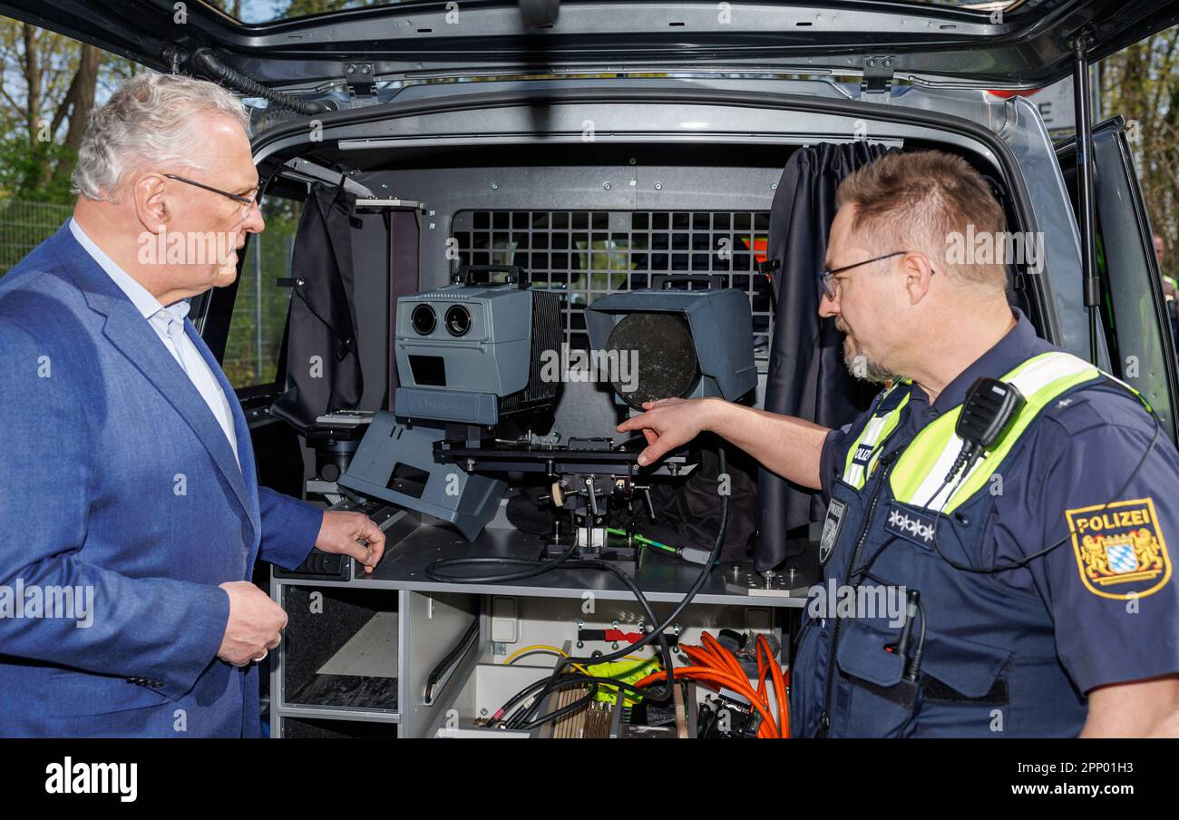 21. April 2023, Bayern, Nürnberg: Chefinspektor Dirk Klinge (r), Leiter der Nürnberger Verkehrspolizei, erläutert den Betrieb des Geschwindigkeitsmesssystems PoliScan FM1 von Vitronic bis zum bayerischen Innenminister Joachim Herrmann (CSU) während des sogenannten Blitzmarathons. An rund 1800 Messpunkten in ganz Bayern halten die Polizei und die Mitarbeiter der Kommunen sowie die örtlichen Verkehrskontrollbehörden Ausschau nach Schnellfahrern. Vor allem aber werden Kontrollen auch dort durchgeführt, wo die Unfallgefahr durch Geschwindigkeitsüberschreitung am größten ist oder wo speedi auftritt Stockfoto