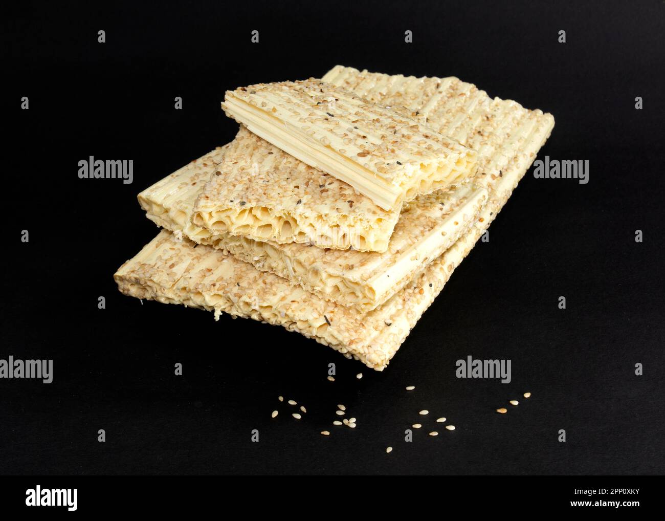 Sesamsamen-Honigriegel isoliert auf schwarzem Hintergrund. Sesamsamen-Kozinaki. Sesamum indicum L. Stockfoto