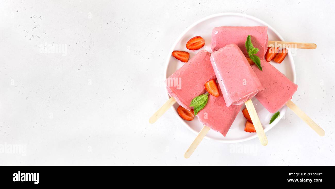 Erdbeer-Eis-Eis-Eis-Eis auf weißem Teller über weißem Stein Hintergrund mit freien Text Raum. Draufsicht, flach liegend Stockfoto