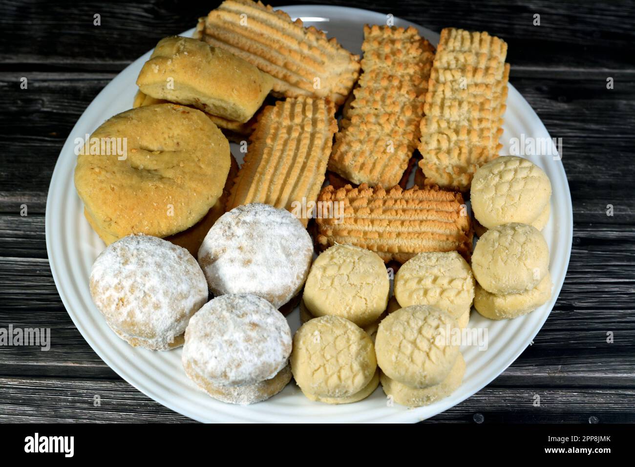 Traditionelle arabische Kekse zur Feier islamischer Feiertage El-Fitr Festmahl, ägyptisches Ghoriba aus Ghee, ägyptisches Kahk mit Puderzucker bedeckt Stockfoto
