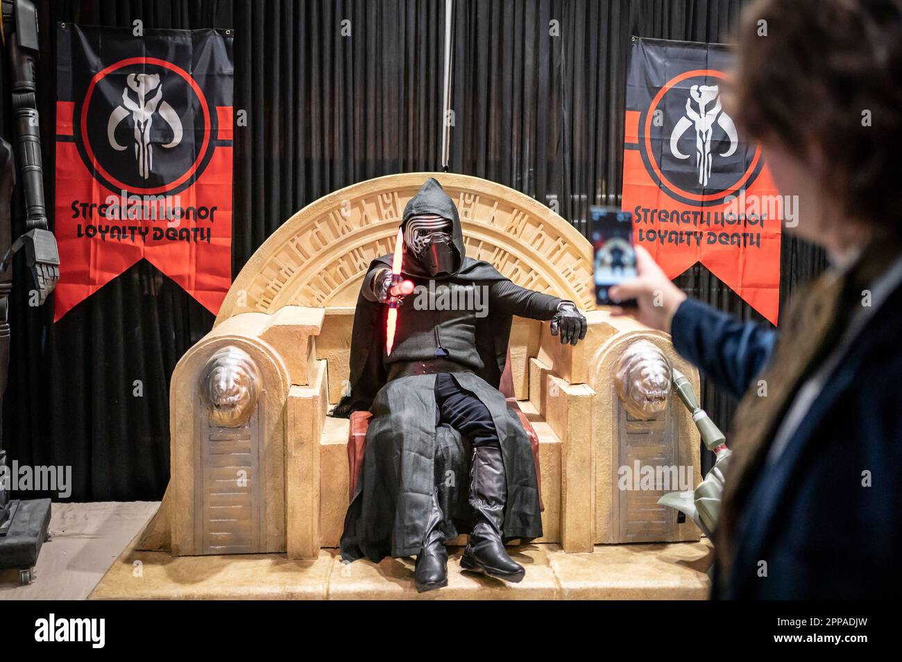 Ashley Pickering, verkleidet als Kylo Ren von der Star Wars-Reihe, lässt sich während des Sci Fi Scarborough im Spa Complex in Scarborough auf einer Nachbildung von Boba Fett's Thron fotografieren. Foto: Sonntag, 23. April 2023. Stockfoto