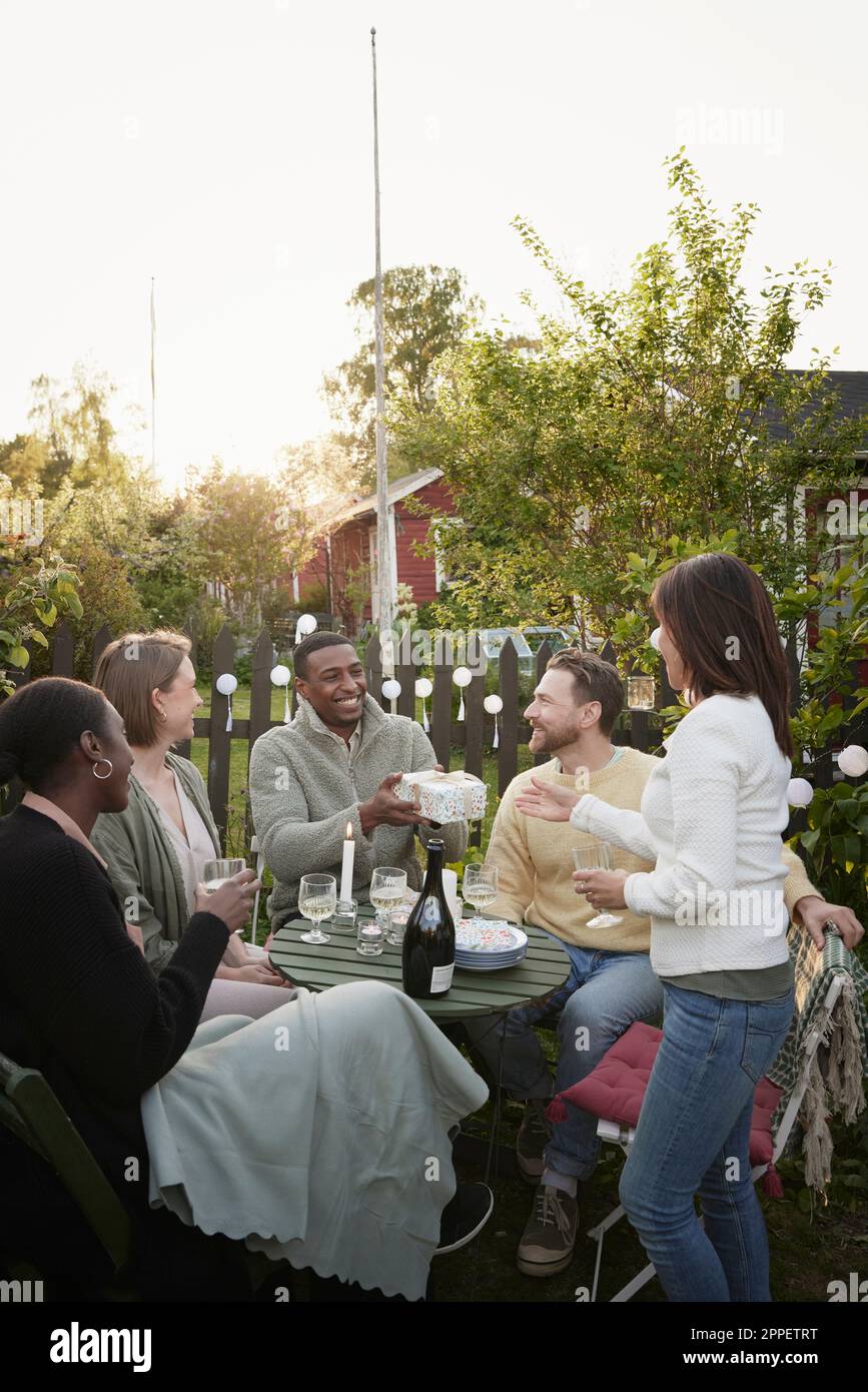 Fröhliche Freunde feiern im Garten Stockfoto