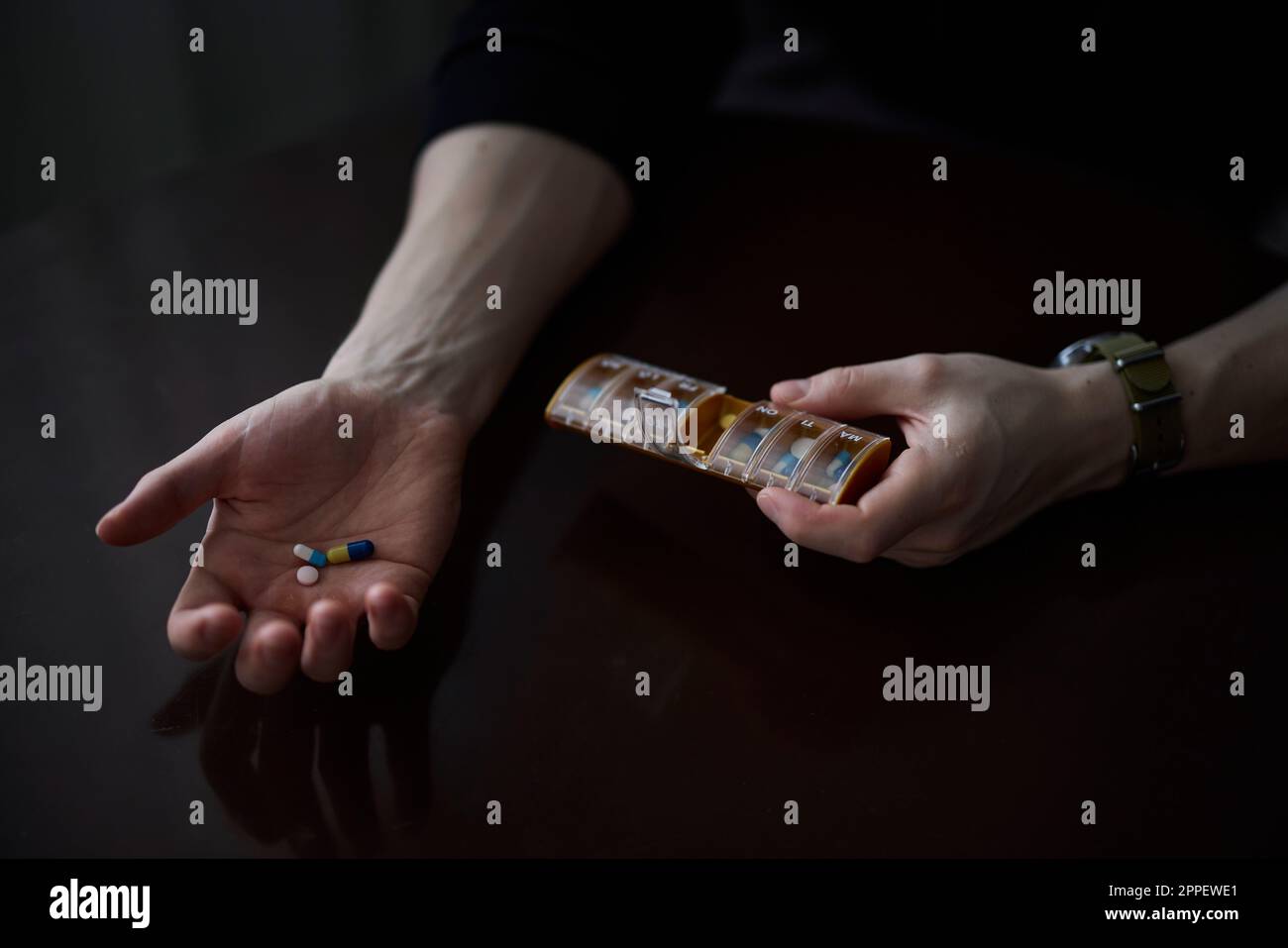 Frauenhände halten Box mit Pillen Stockfoto