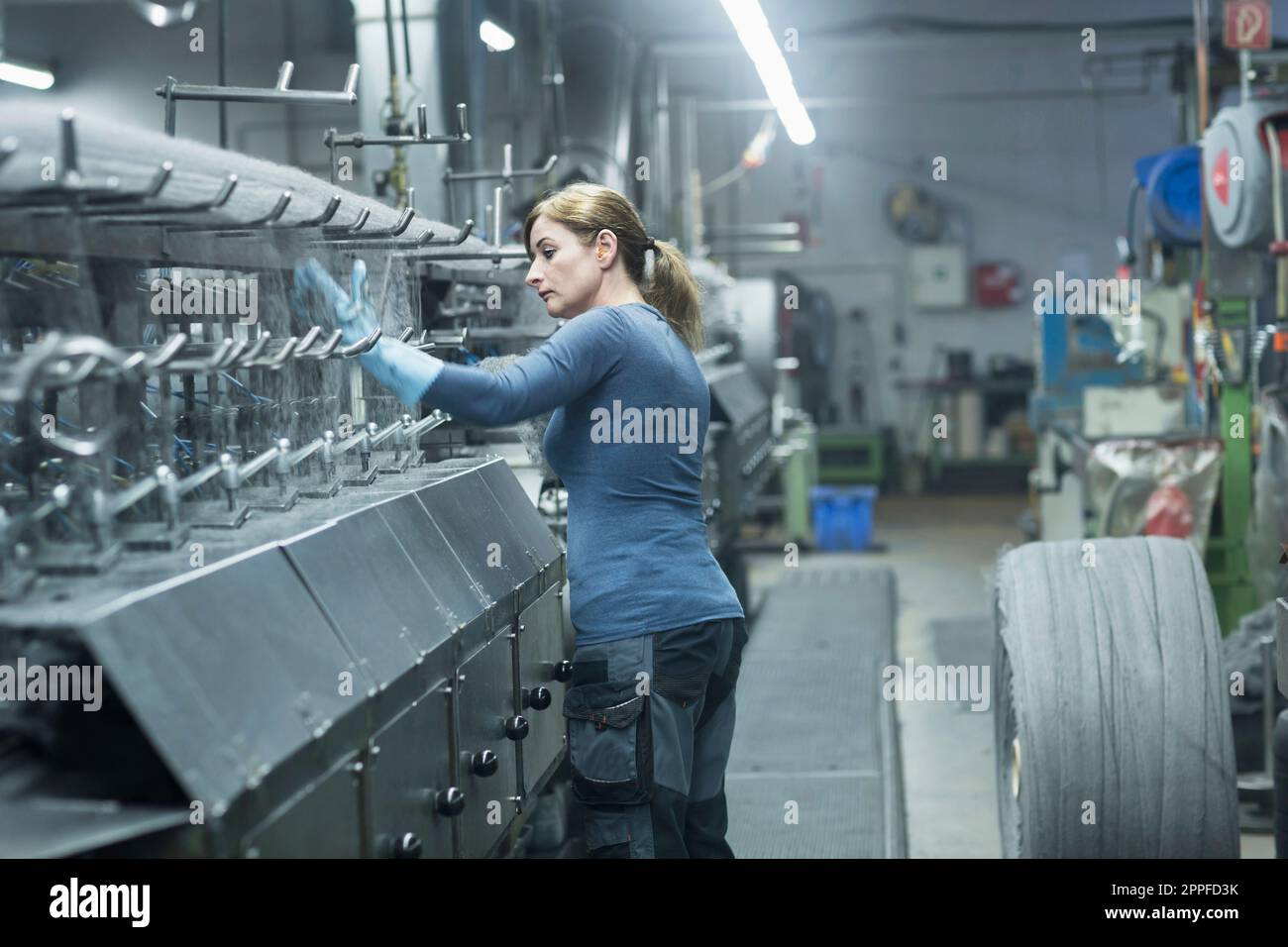 Reife Frau, die in der Stahlwollreiniger-Industrie, Lahr, Baden-Württemberg, Deutschland, arbeitet Stockfoto
