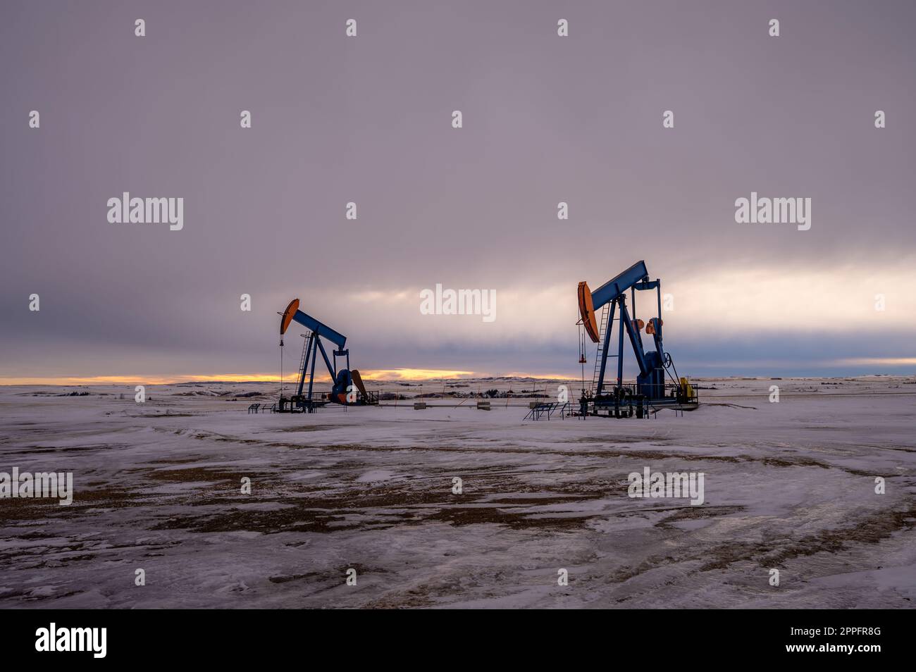 Ölpumpenheber laufen in der Dämmerung Stockfoto