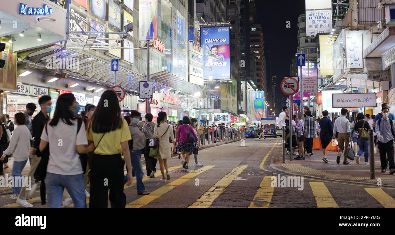 Mong Kok, Hongkong, 10. Dezember 2020: Menschen gehen nachts auf der Straße Stockfoto
