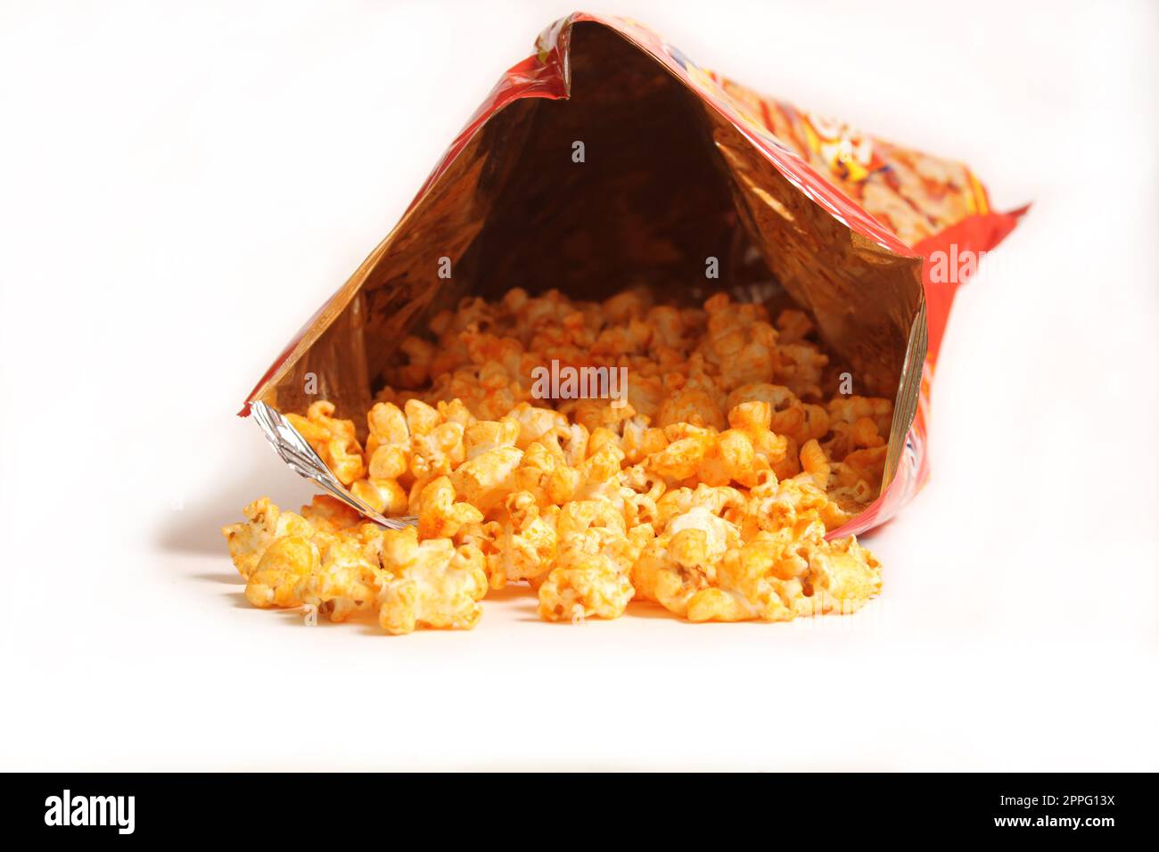Offene Tüte mit gewürztem Popcorn isoliert auf weißem Hintergrund Stockfoto