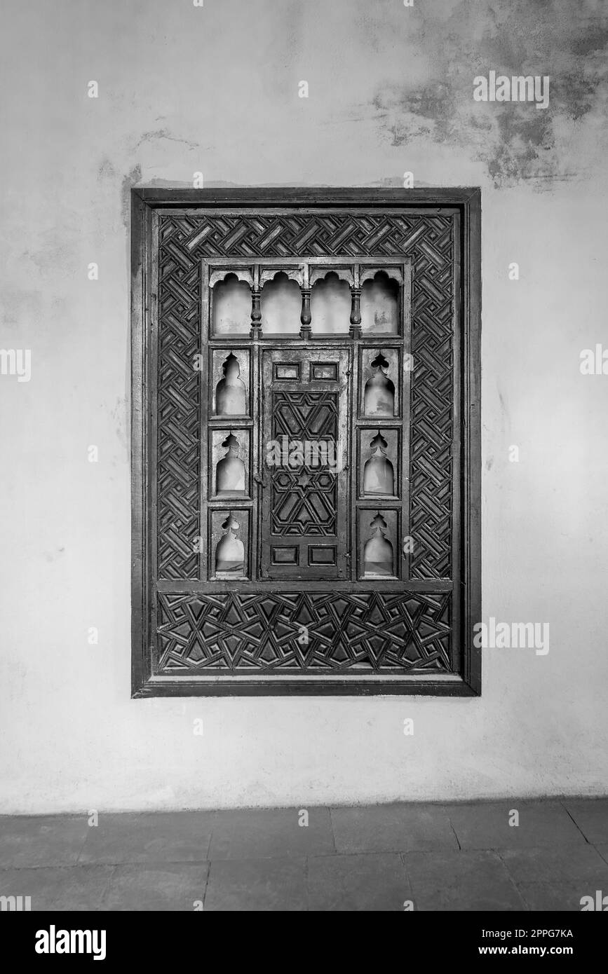 Schrank aus der Ottomanenzeit aus Holz mit eingravierter Dekoration, eingebettet in eine Grunge-Wand Stockfoto