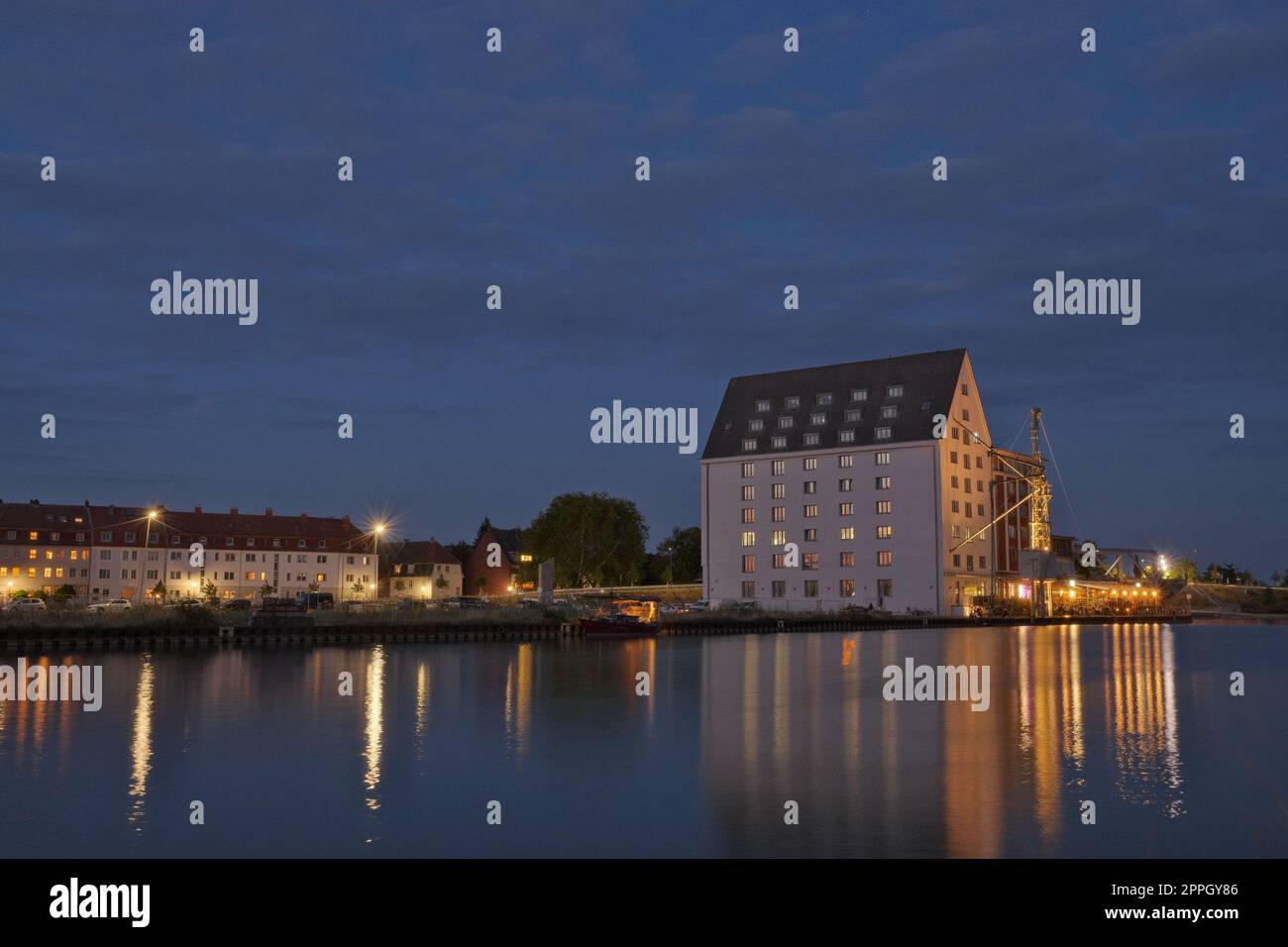 Beleuchtetes Haus bei Sonnenuntergang im Hafen von Munster, Deutschland Stockfoto