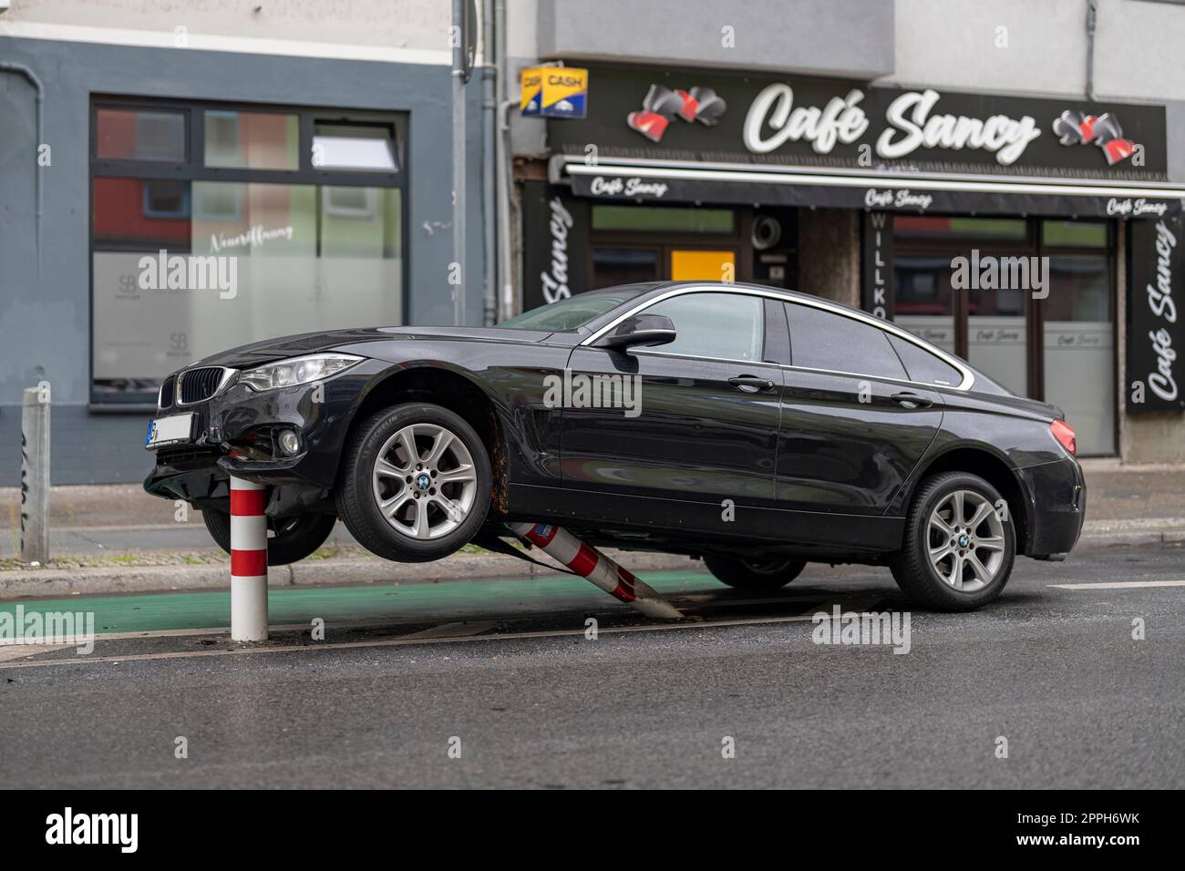 In den frühen Morgenstunden stieß ein Pkw auf die Poller einer Fahrradstrecke im verkehrsberuhigten HermannstraÃŸe (Geschwindigkeit 30 km/h) in Berlin und erlitt erhebliche Schäden am Unterboden und Motorraum. Der Fahrer floh und verließ das Fahrzeug Stockfoto