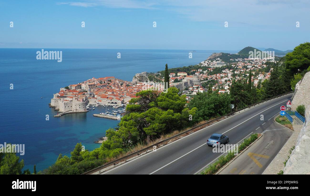 Straßenverkehr in der Nähe der Altstadt von Dubrovnik in Kroatien. Dubrovnik Ragusa ist eine Stadt in Kroatien, dem Verwaltungszentrum des Bezirks Dubrovnik-Neretva. Blick von oben von der Aussichtsplattform auf den Felsen. Stockfoto