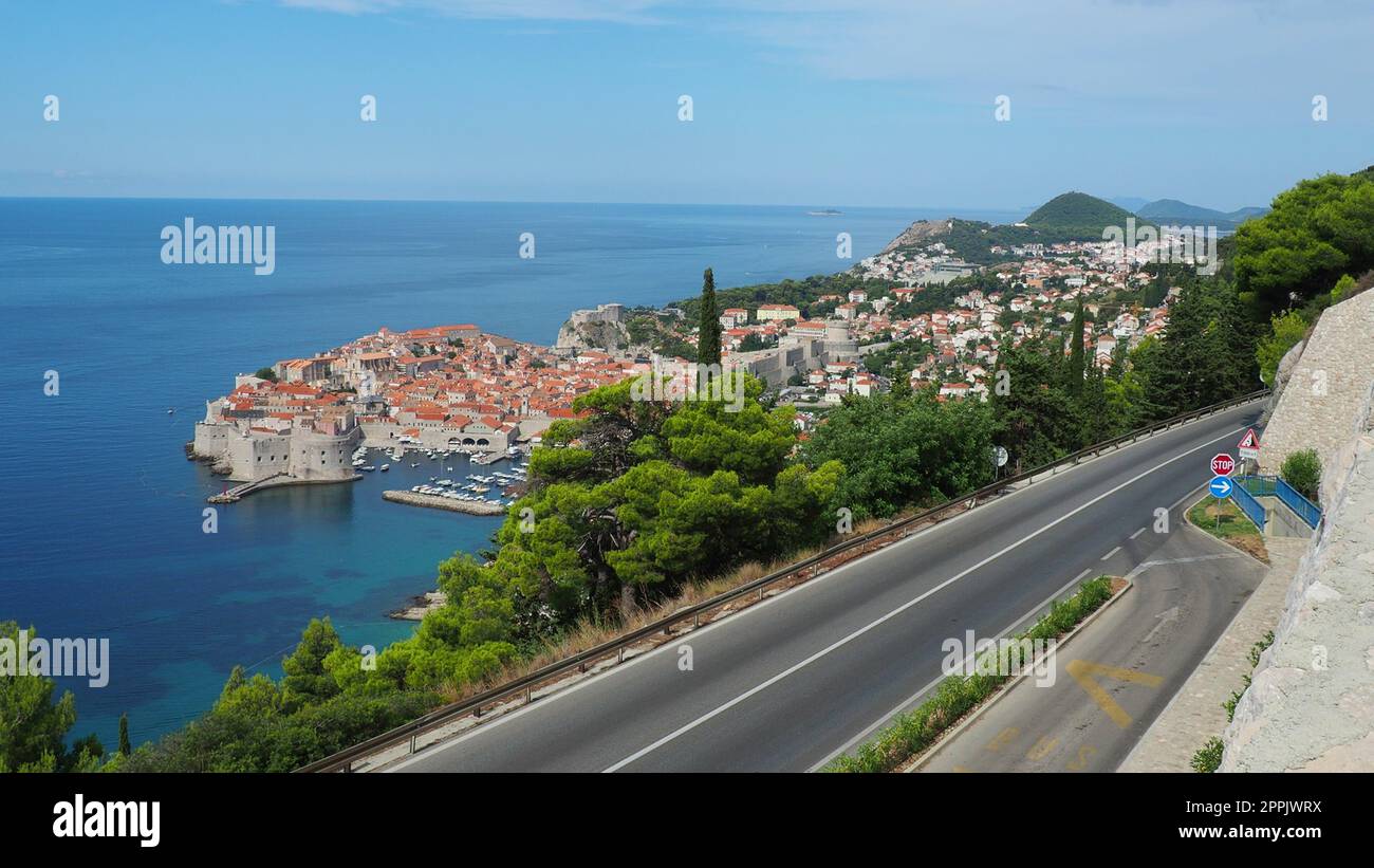 Straßenverkehr in der Nähe der Altstadt von Dubrovnik in Kroatien. Dubrovnik Ragusa ist eine Stadt in Kroatien, dem Verwaltungszentrum des Bezirks Dubrovnik-Neretva. Blick von oben von der Aussichtsplattform auf den Felsen. Stockfoto