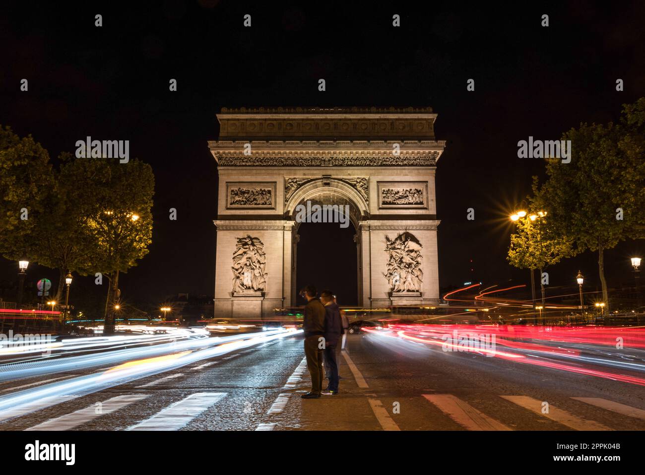 Nächtlicher Verkehr auf den Champs-Elysées, Arc de Triomph im Hintergrund Stockfoto