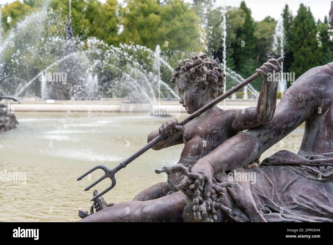 Skulptur eines kleinen Jungen mit einem Dreizack im Schlossgarten von Herrenchiemsee Stockfoto