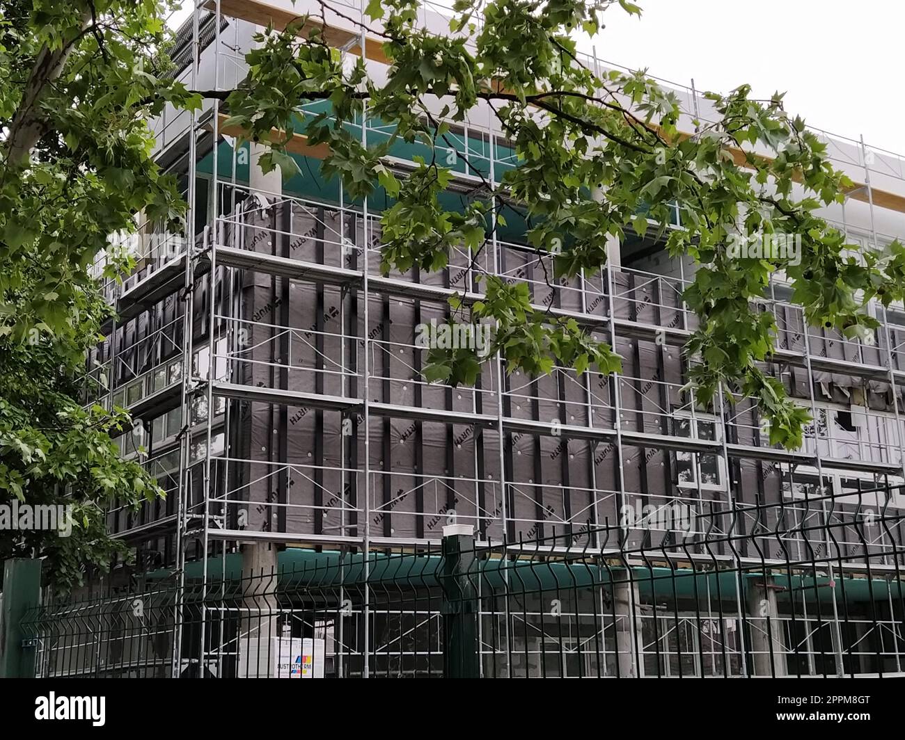 Sremska Mitrovica, Serbien, 30. Mai 2020. Bau eines neuen Schulgebäudes. Gerüste an der Fassade. Metallzaun. Ich beende die Arbeit Stockfoto