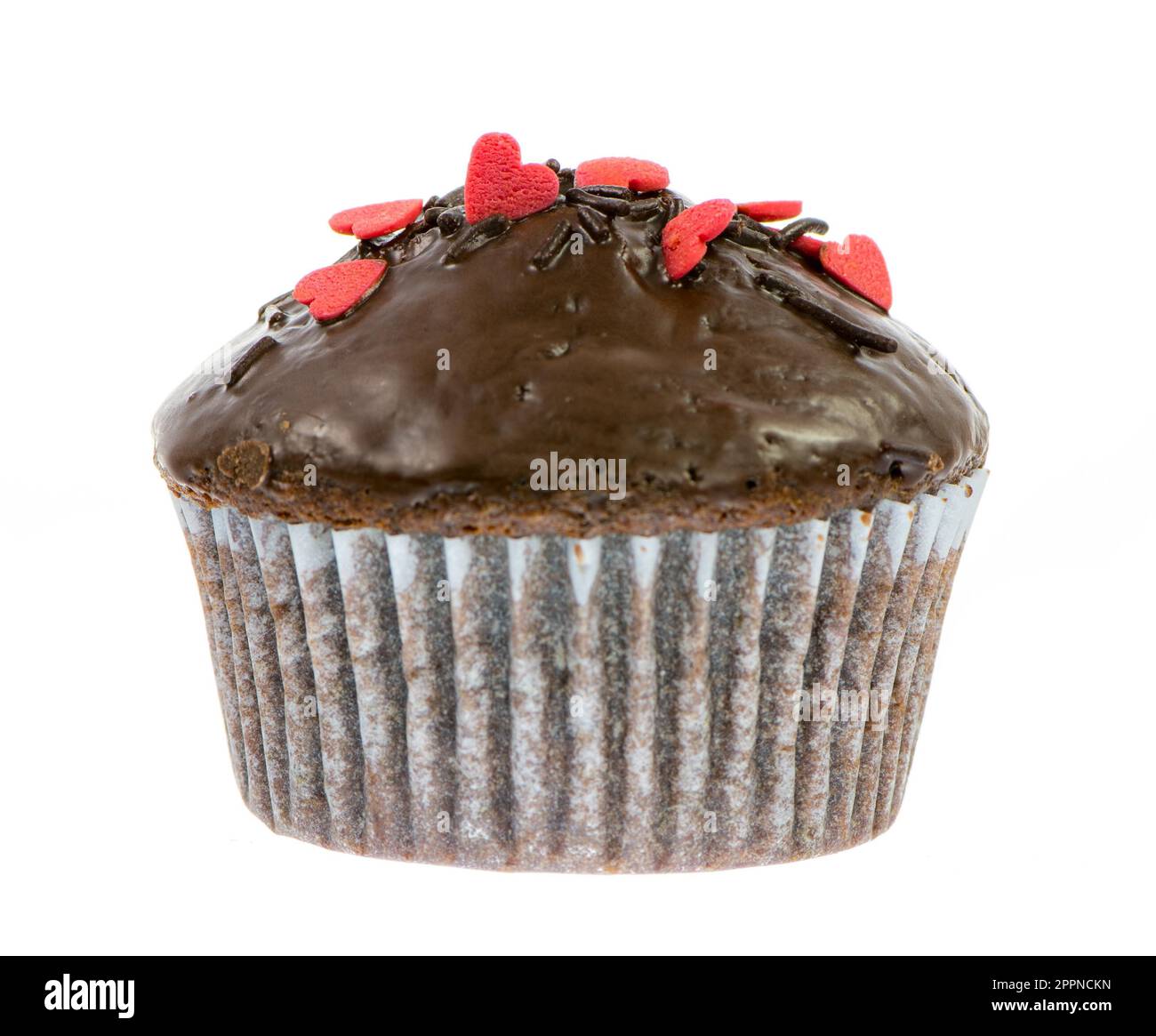 Nahaufnahme von einem isolierten Schoko-Muffin mit roten Zuckerherzen Stockfoto