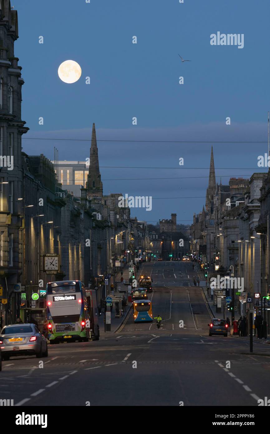 The Setting Full Moon (Pink Moon) über dem westlichen Ende der Union Street im Stadtzentrum von Aberdeen früh am Morgen vor der Daybreak Stockfoto