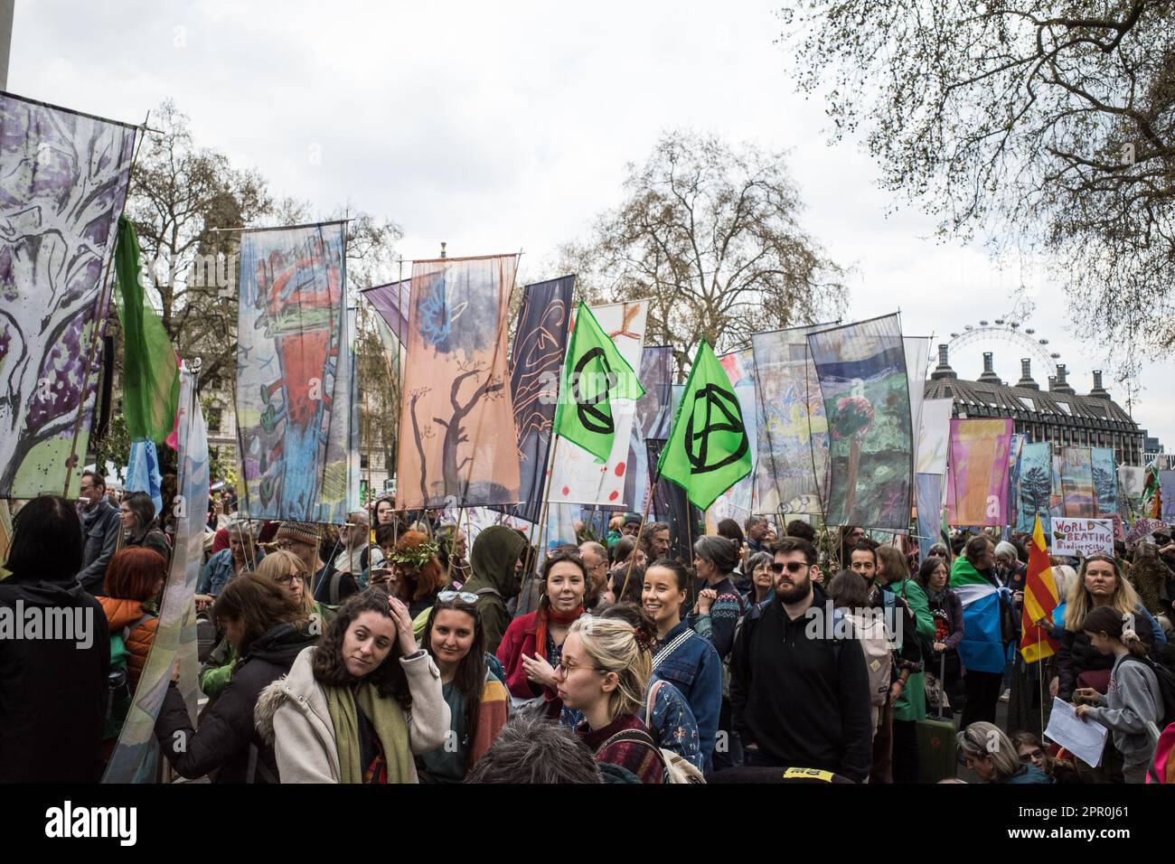 Viele Demonstranten der "Extinction Rebellion" halten Banner und Flaggen in der Hand, während sie auf den marsch nach Westminster, dem Earth Day 2023, warten. Nach London. Der Große. Stockfoto