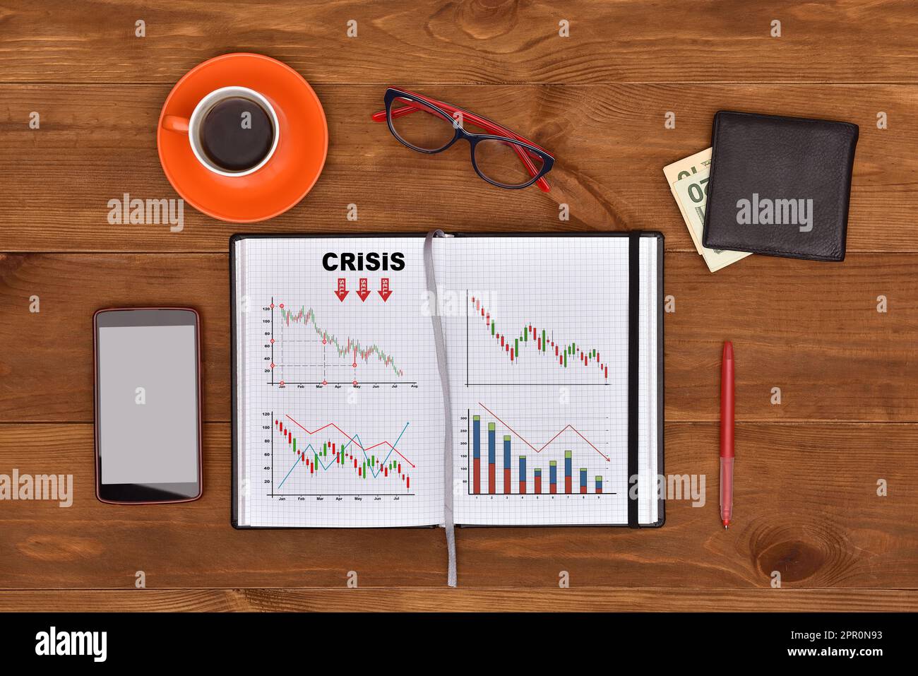 Zeichnen von Krisenkonzepten in Notizblock und Geschäftselementen auf einem Schreibtisch Stockfoto